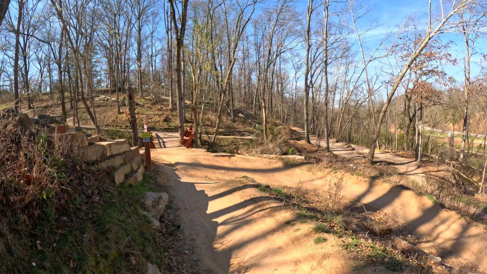 A picture of where All American intersects with the Highway to Heaven trail before weaving under the pedestrian bridge and intersecting with the Razorback Greenway near The Masterpeice Trail