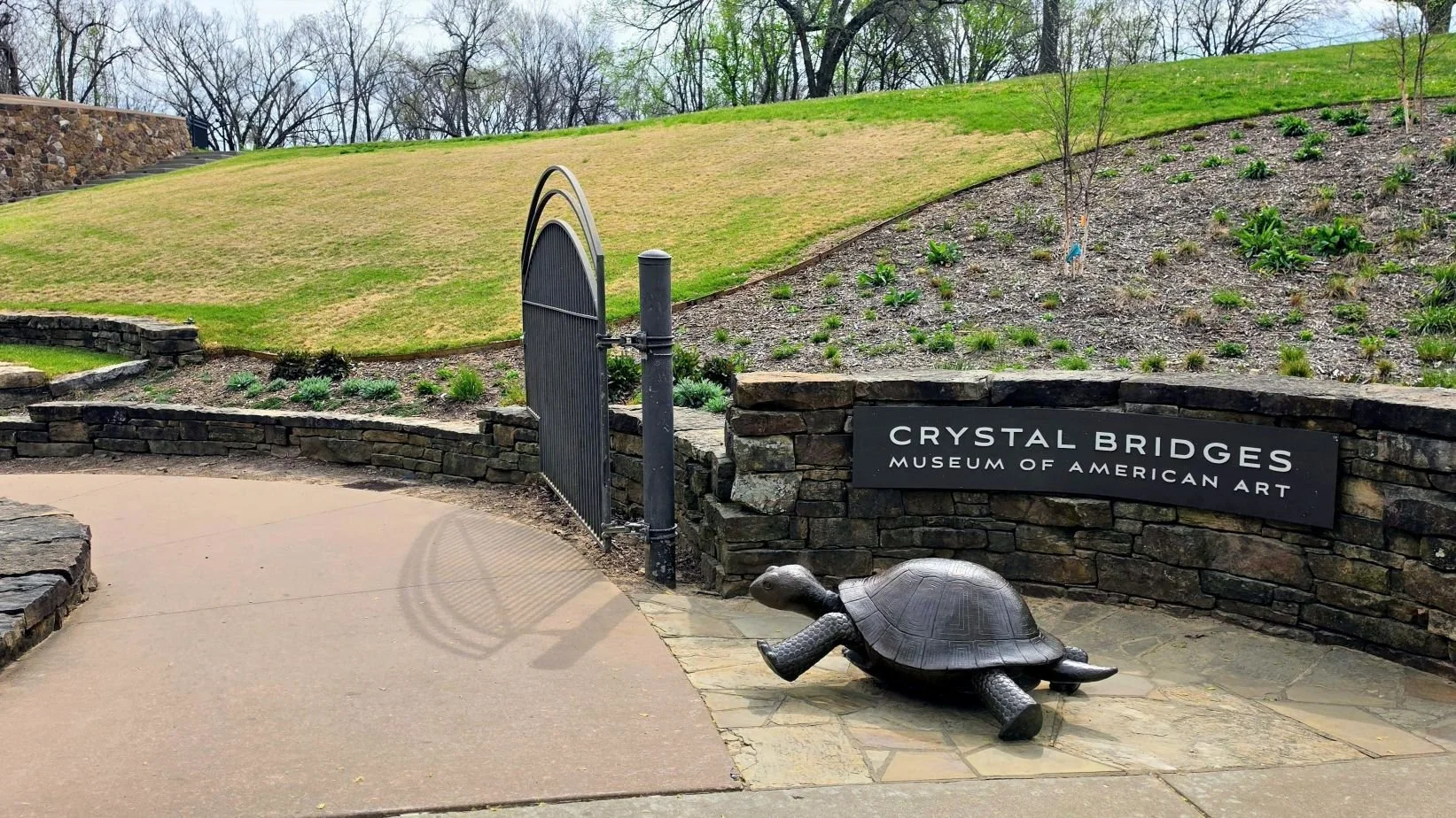 The Art trail entrance has a statue of a turtle pointing the way into the Crystal Bridges