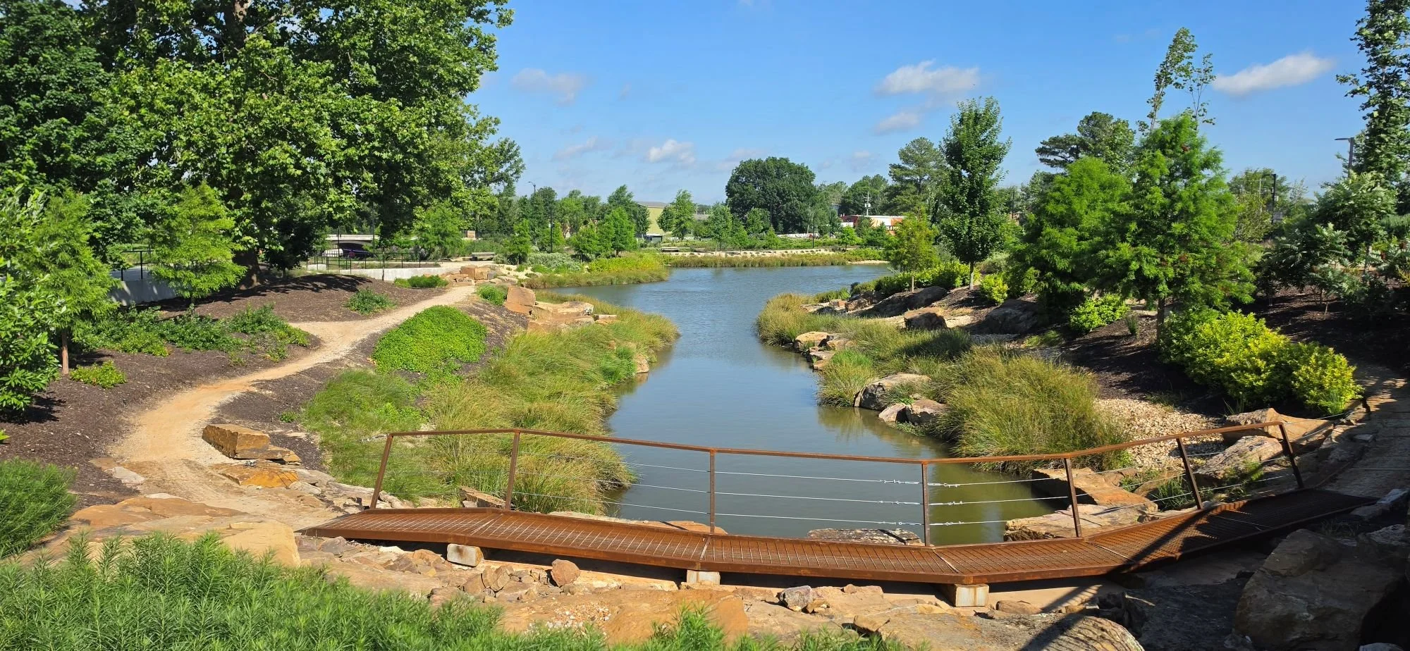 An image of a metal bridge over part of the lake