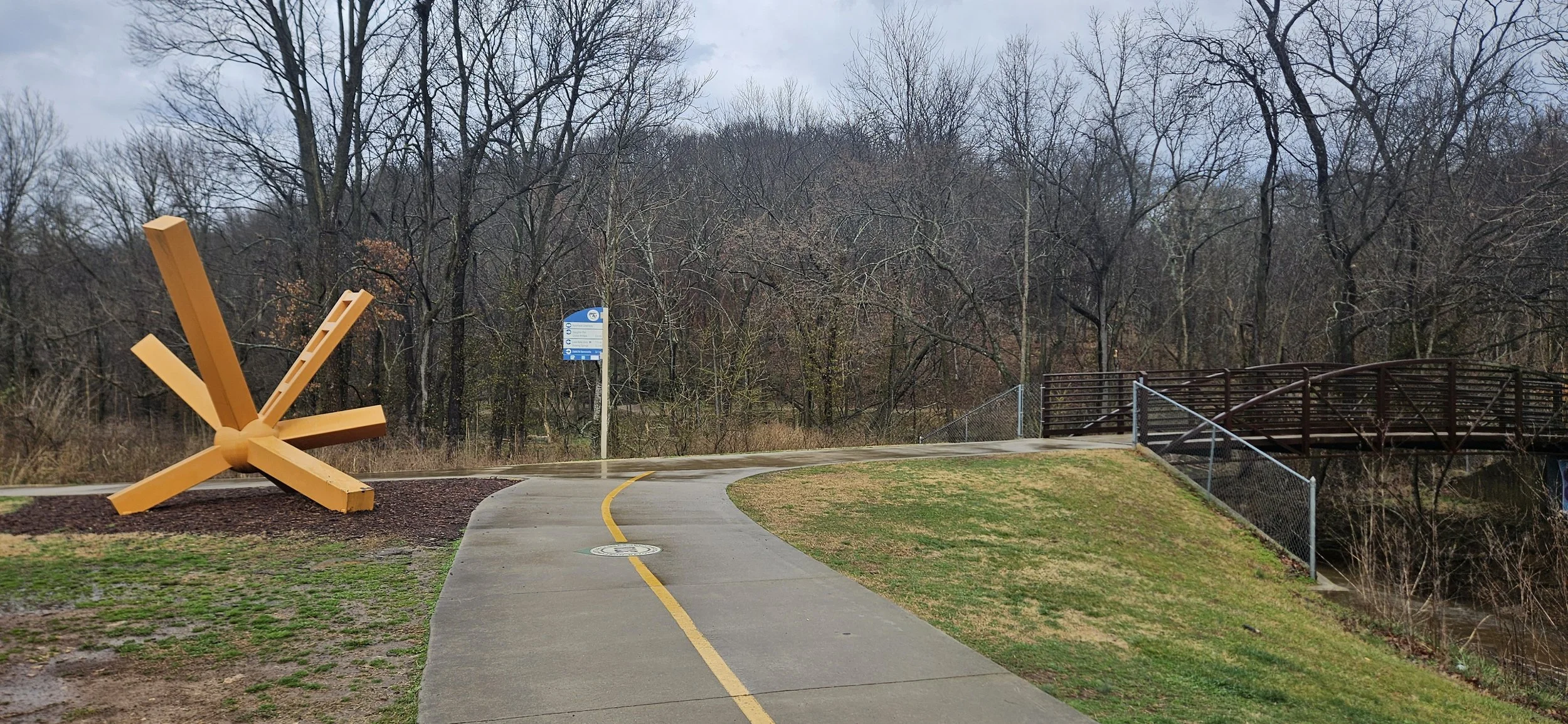 An image of one of the statues along side the razorback greenway after a bridge in Slaughter Pen