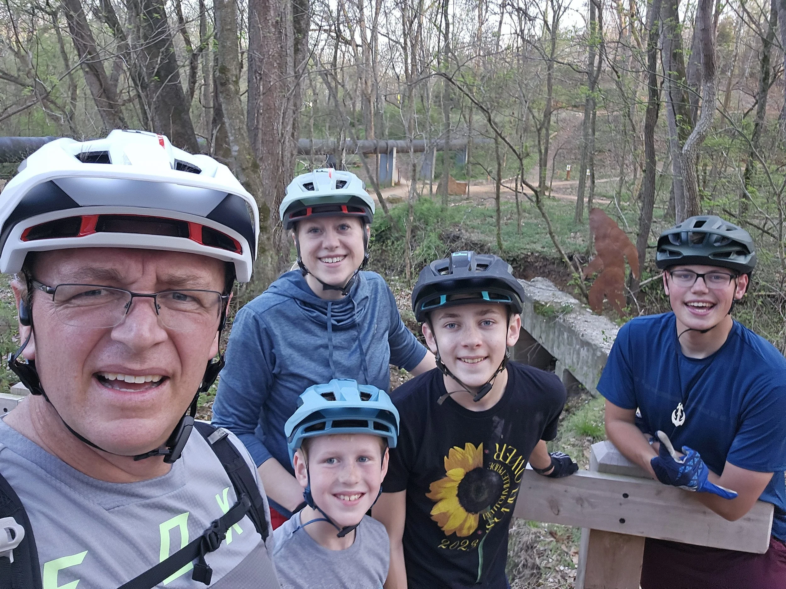 A Picture of a family on Black Apple Trail with a Sasquatch in the background