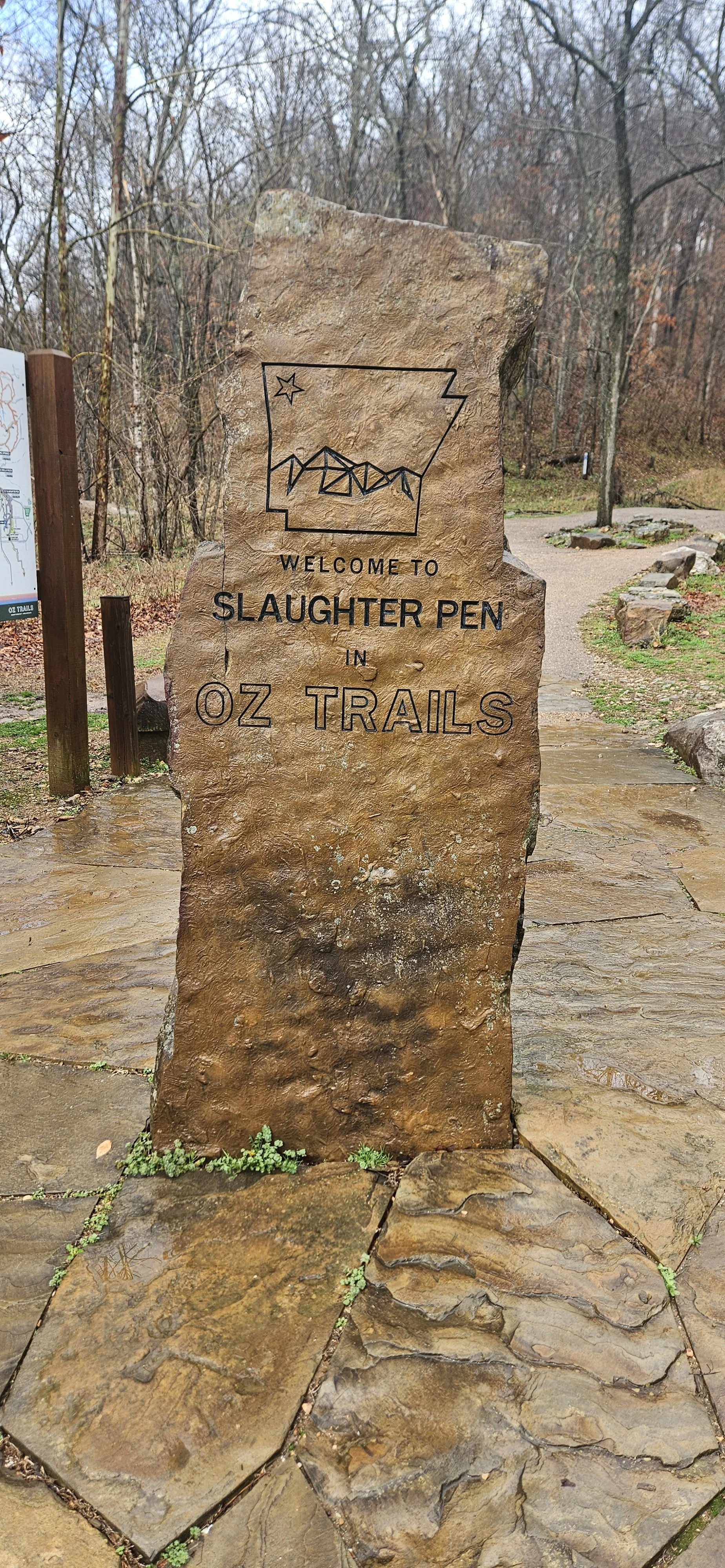 A rock feature that has Welcome to Slaughter Pen in OZ Trails written as a sign to people entering Slaughter Pen from the North Parking Lot area
