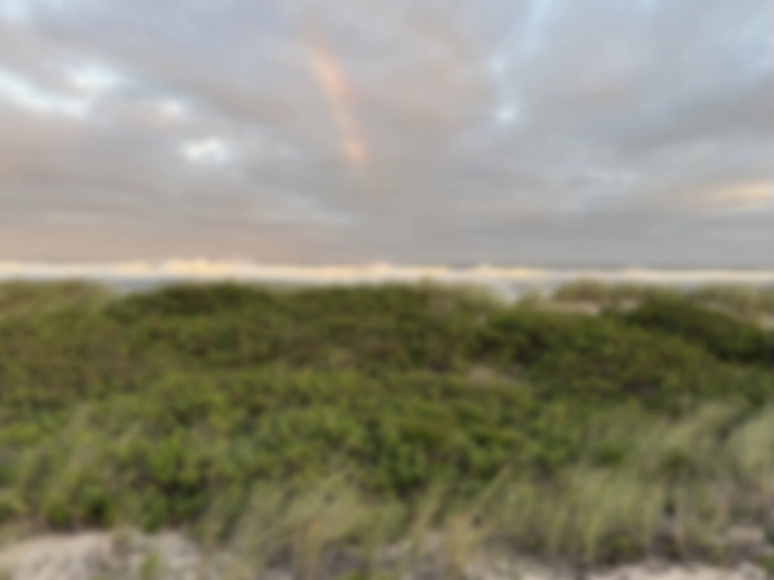 Rainbow peaking over a beach