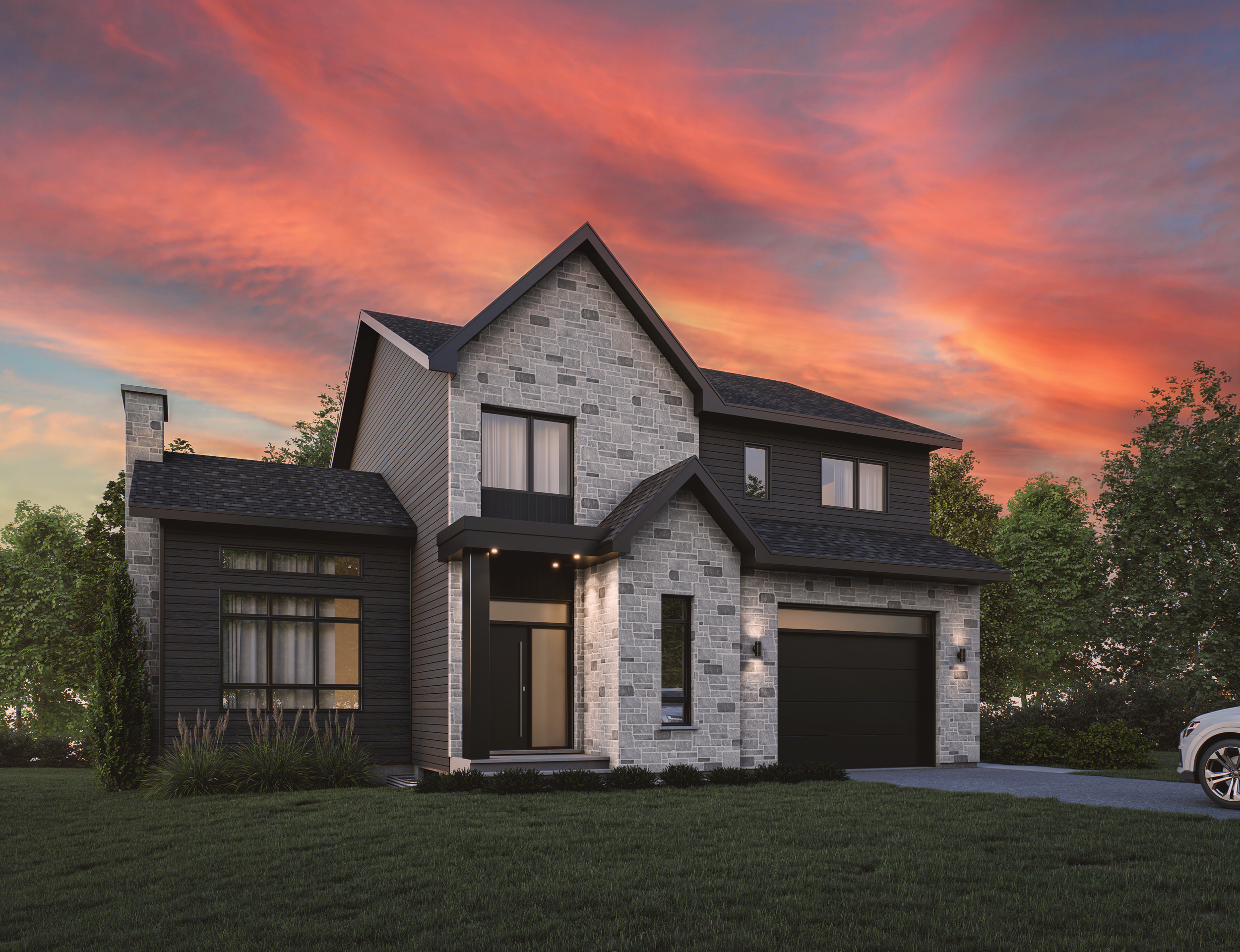 Modern two-story house with stone and black siding exterior, front lawn, driveway with car, sunset sky.