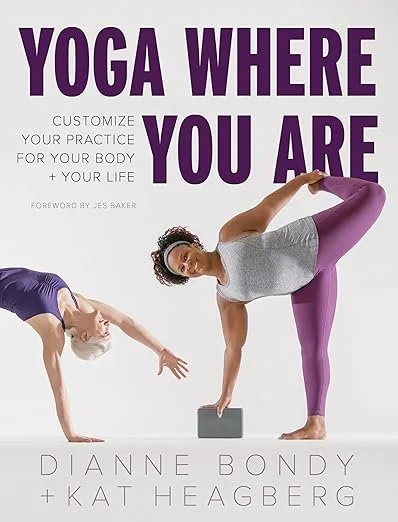 Book cover titled "Yoga Where You Are" by Dianne Bondy and Kat Heagberg, featuring two women practicing yoga poses, one in a leg-extended stretch and the other balancing on one hand and foot.