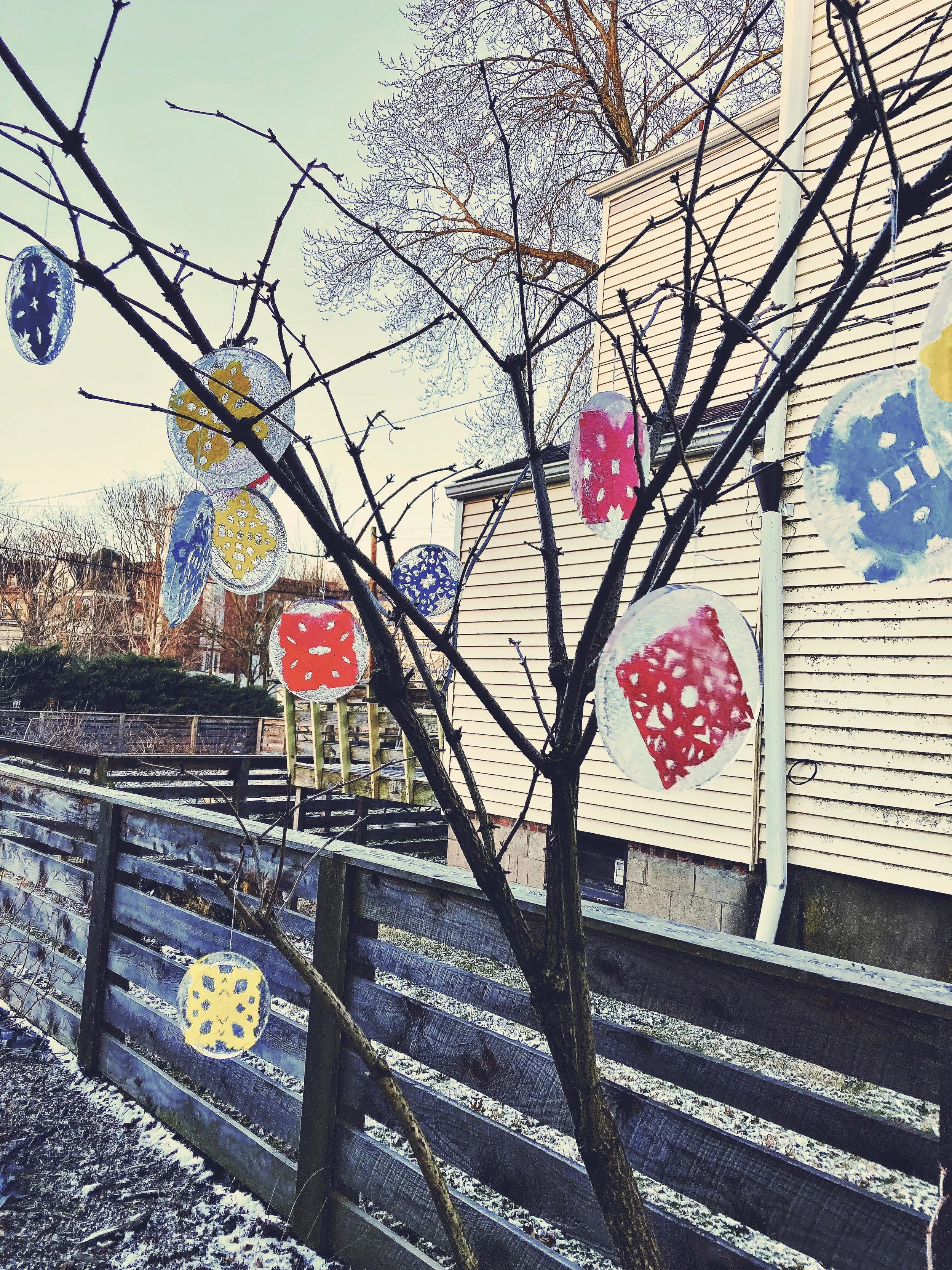 Papercuts inside ice hanging from a winter tree. (Created by O.E. Zelmanovich. Zoe Zelmanovich. Zoe Mizuho)