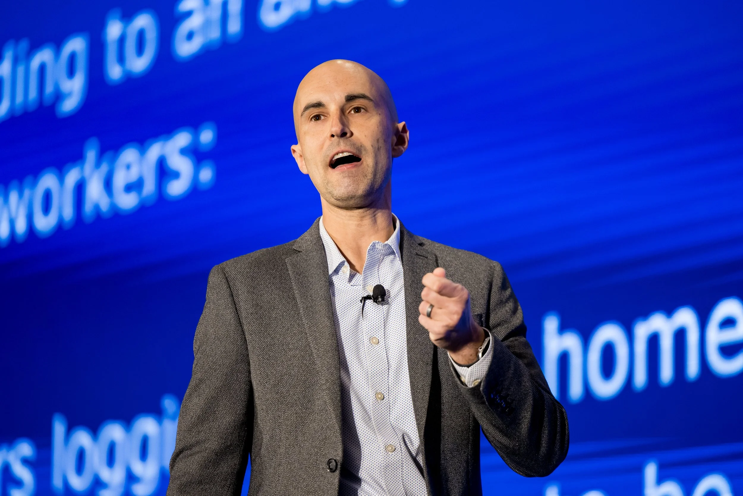 Keynote speaker presenting during a corporate conference event.