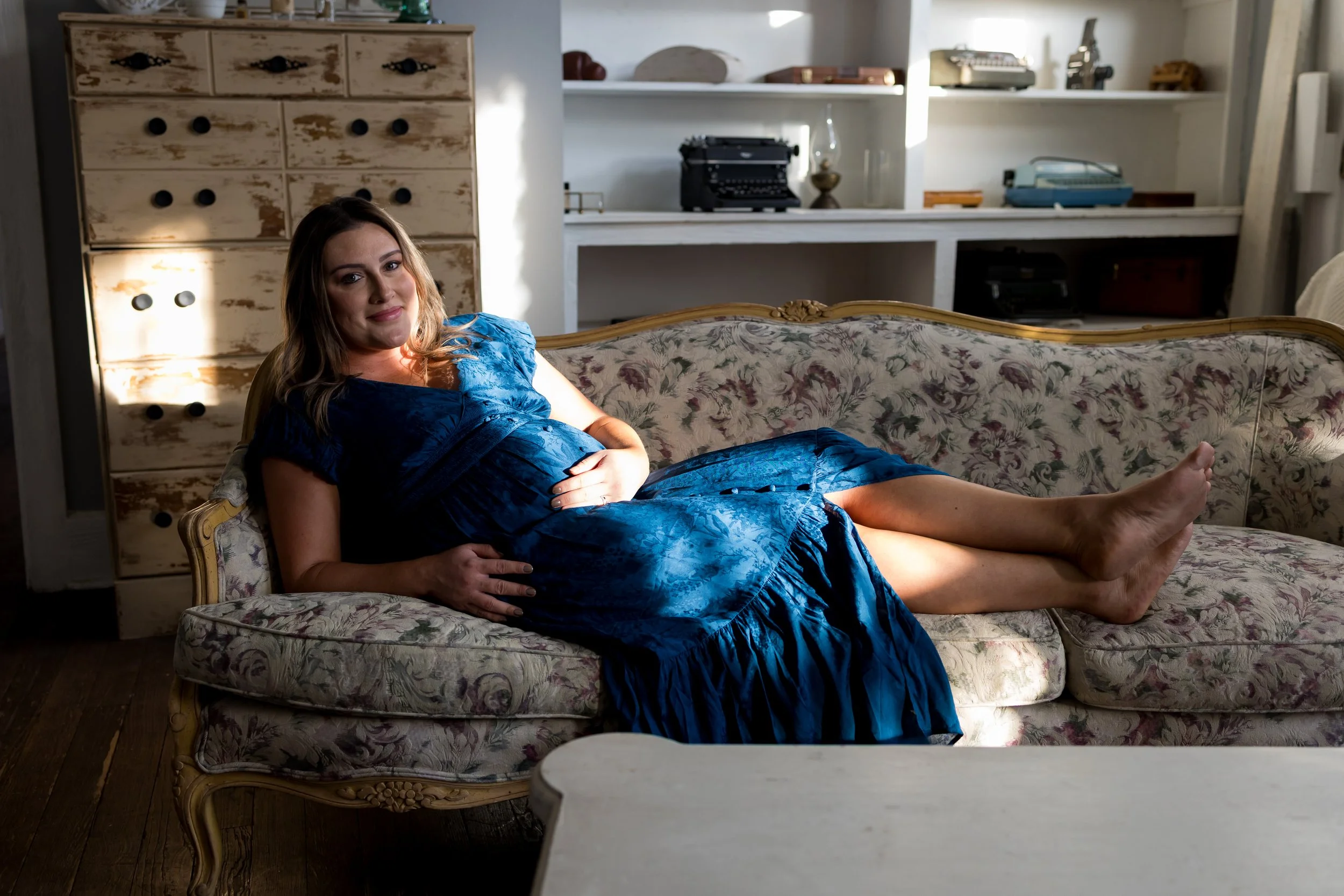 Austin maternity photography session captured indoors using natural light and vintage styling. This lifestyle maternity portrait emphasizes authentic emotion, refined composition, and timeless motherhood imagery.