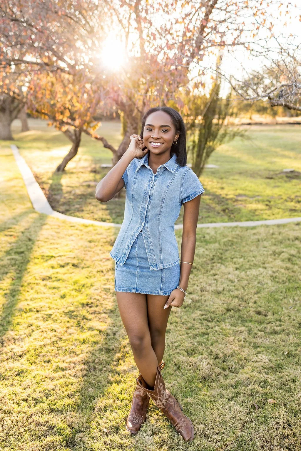 Outdoor lifestyle portrait captured during golden hour in Austin, Texas featuring natural light, soft movement, and elegant styling in a scenic park setting.