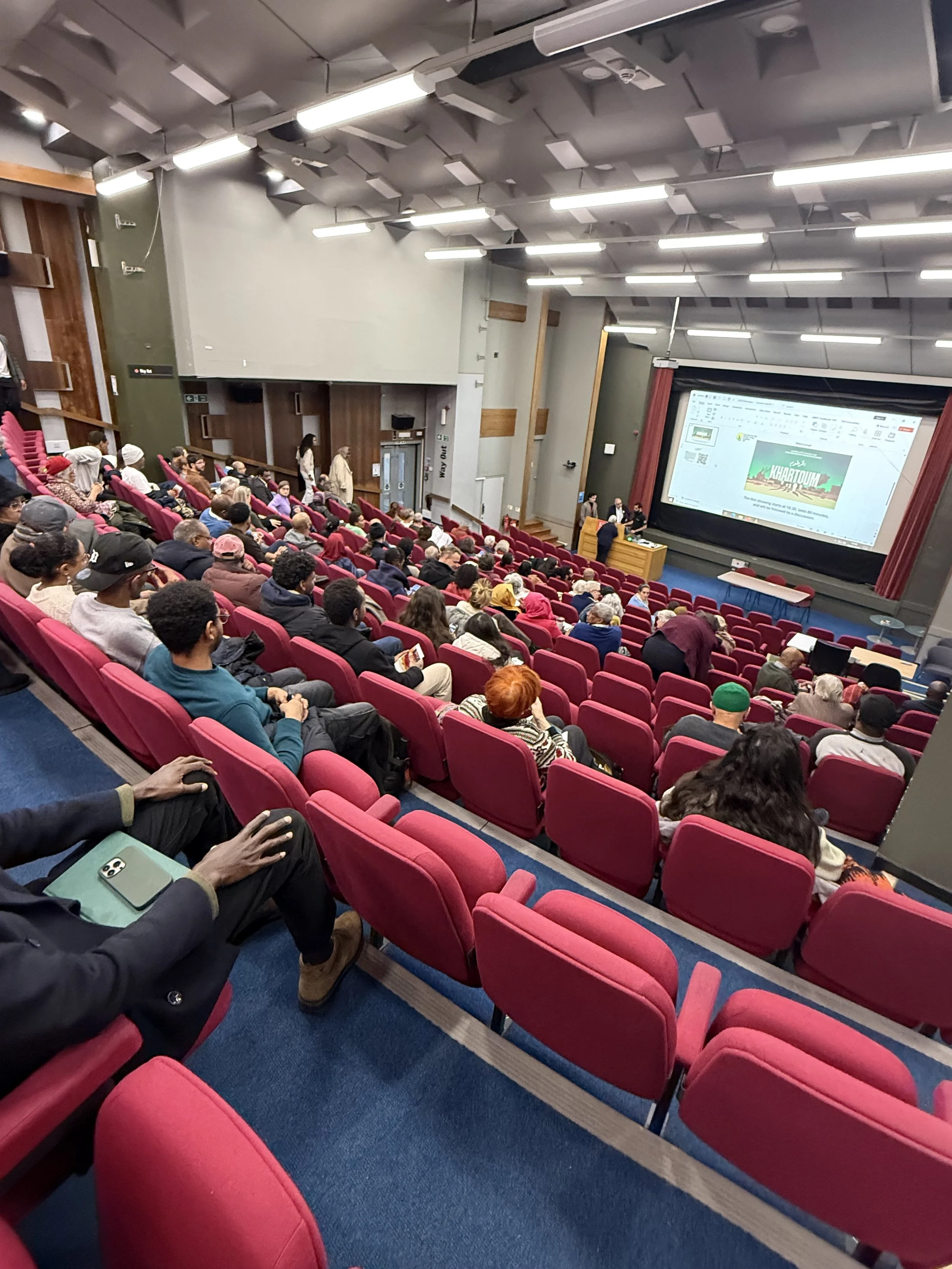 The audience seated in a lecture theatre at King's College London during the showing of the 2026 film 'Khartoum'.