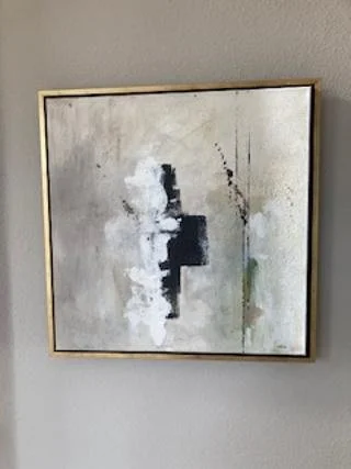 Abstract painting with shades of gray, black, and white, framed in gold, ready to hand
