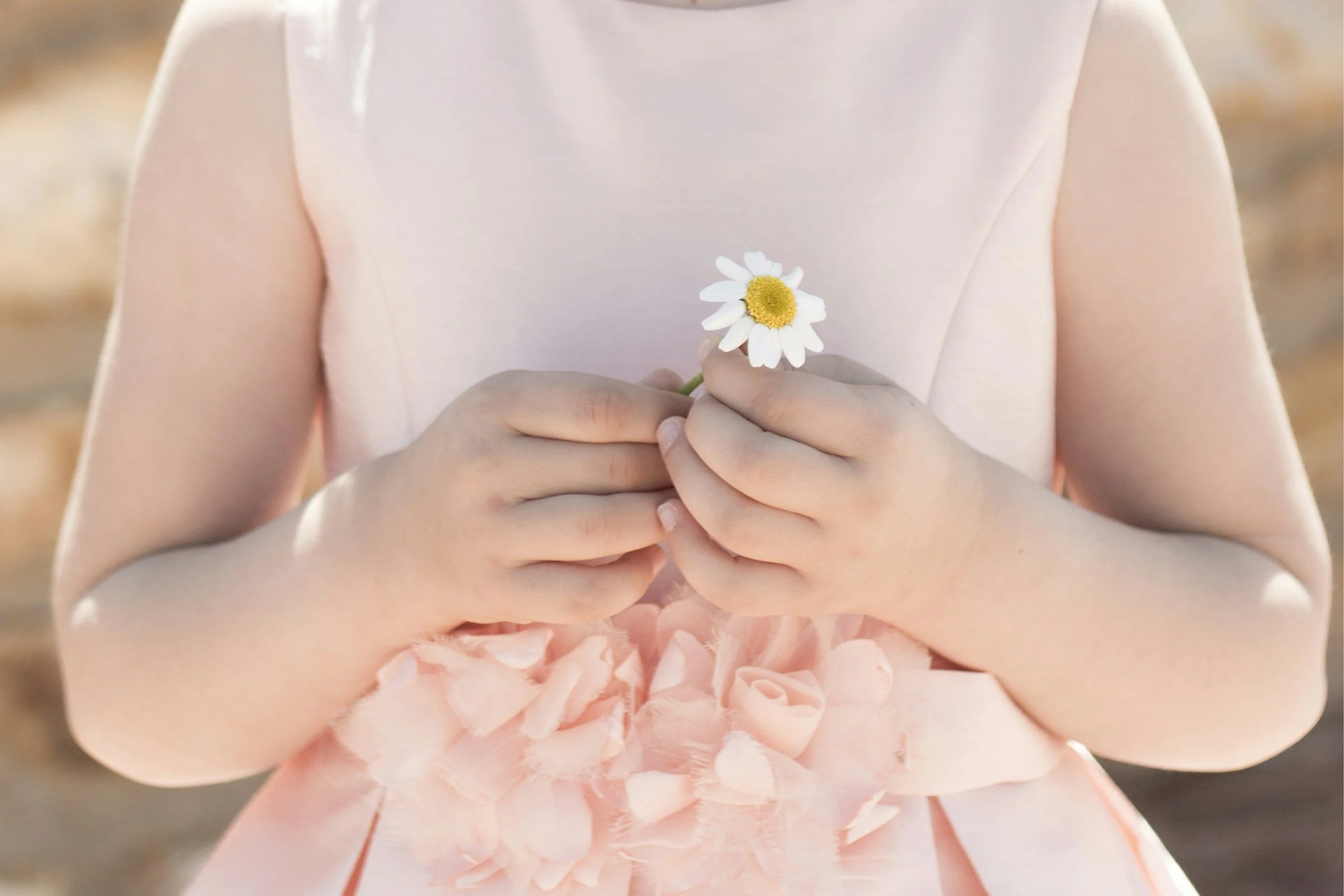 Little girl holding a flower at a party