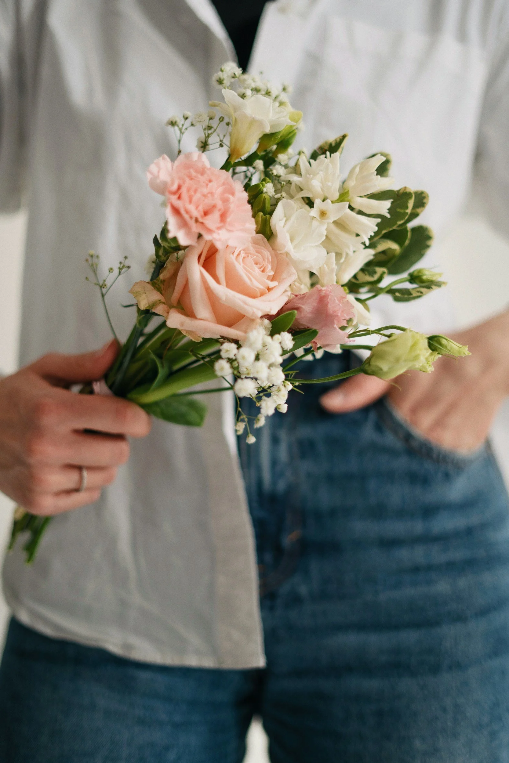 woman holding small bouquet of fresh flowers from a flower bar
