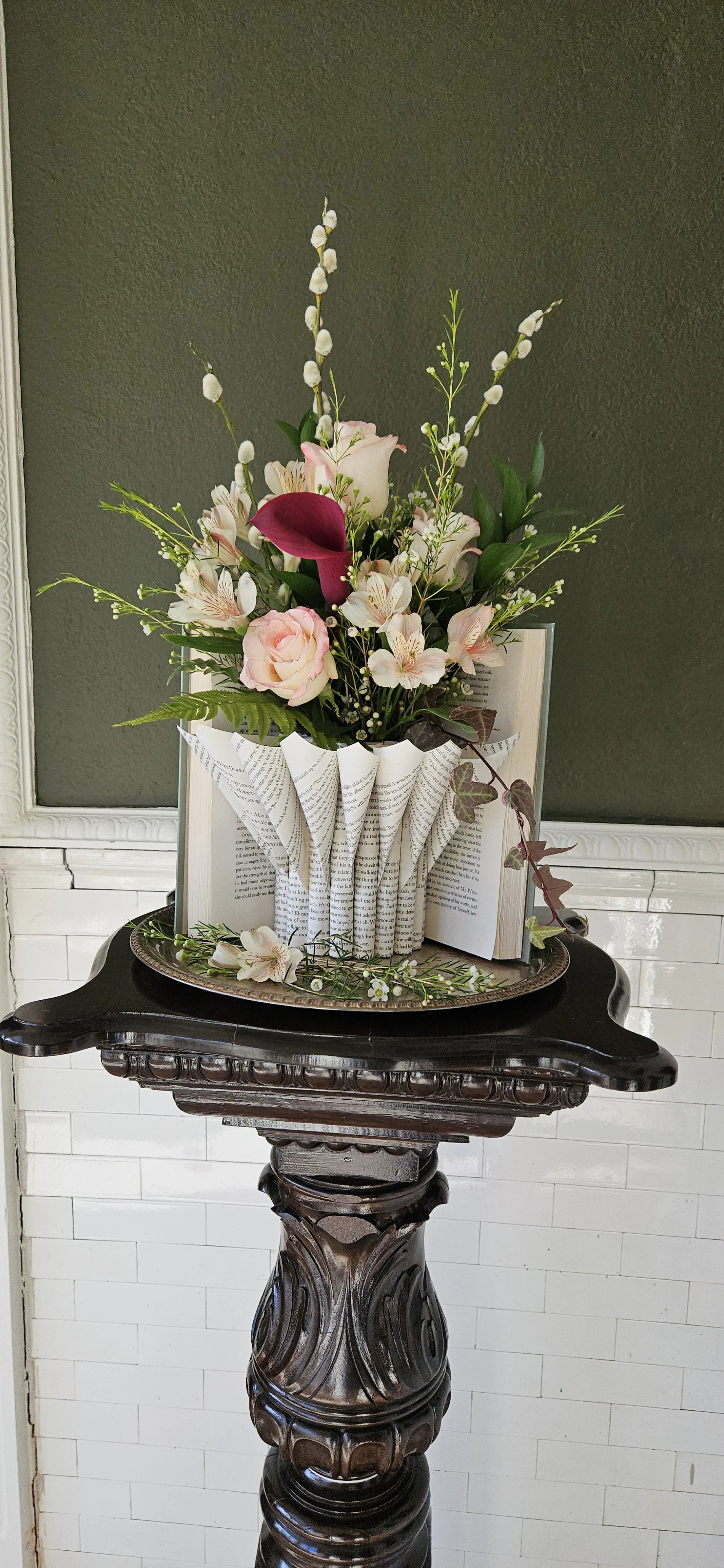 Sculptural book art vase with fresh spring flowers