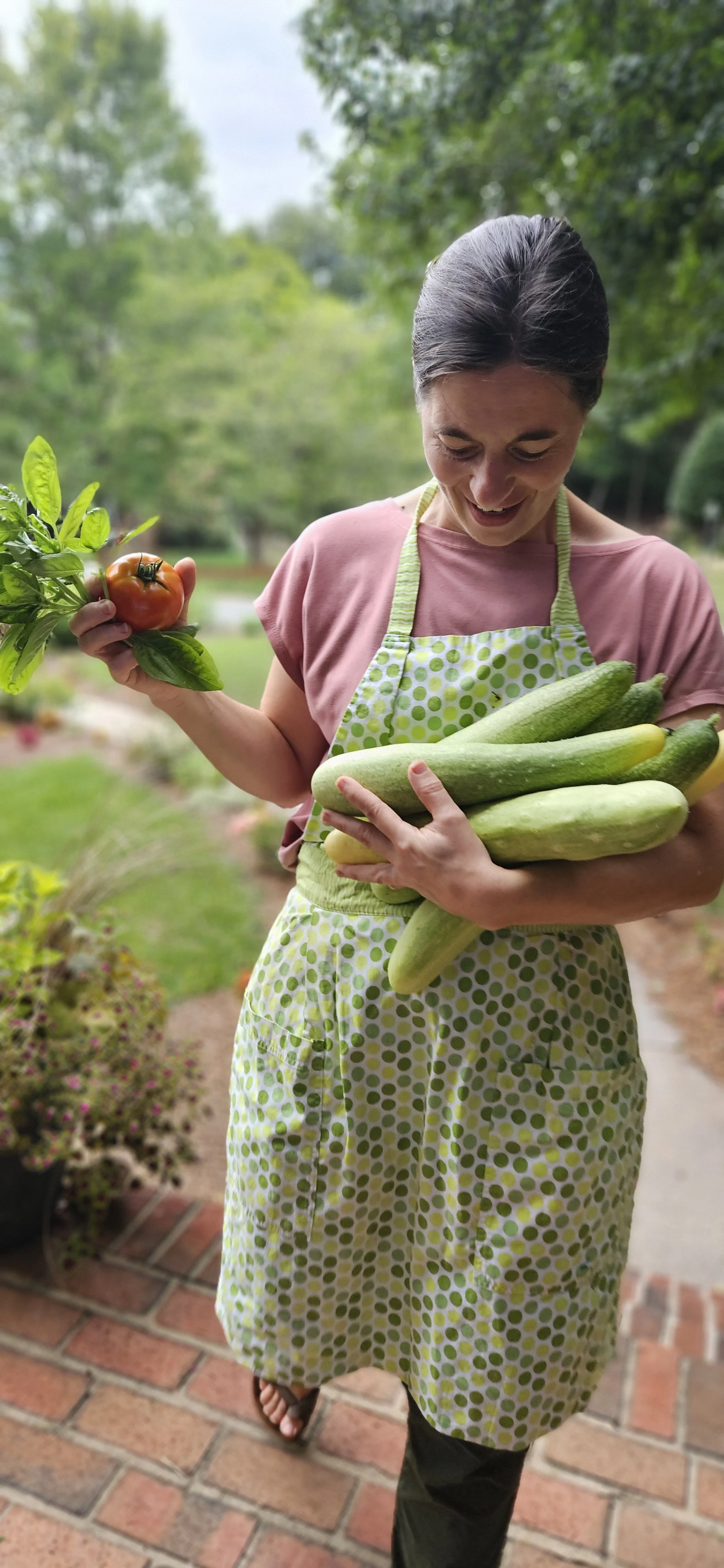 Bethany Ackiss, florist and gardener, carrying vegetables harvested from Clemmons, North Carolina garden