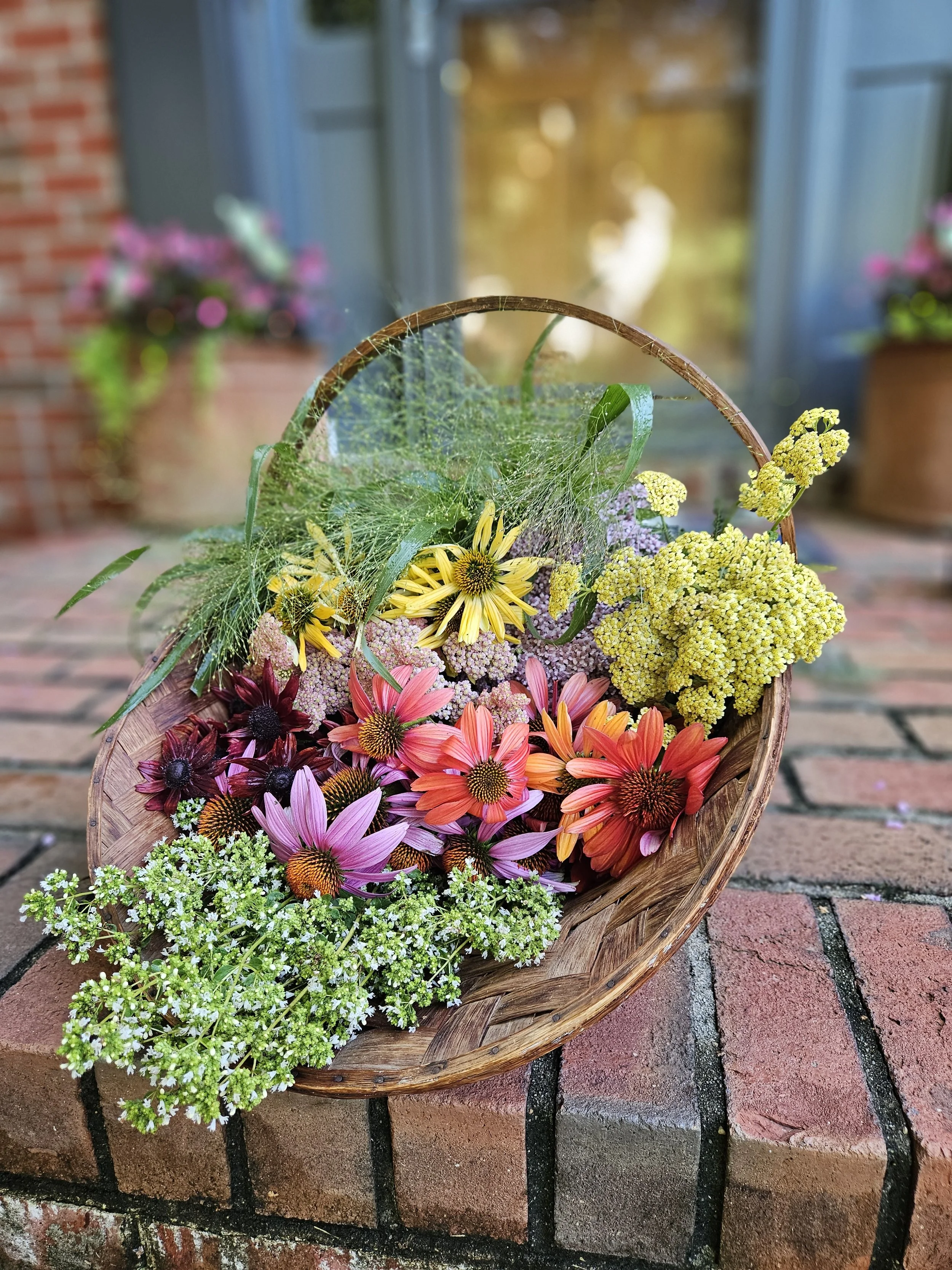 Foraging basket of fresh garden-grown flowers in North Carolina.