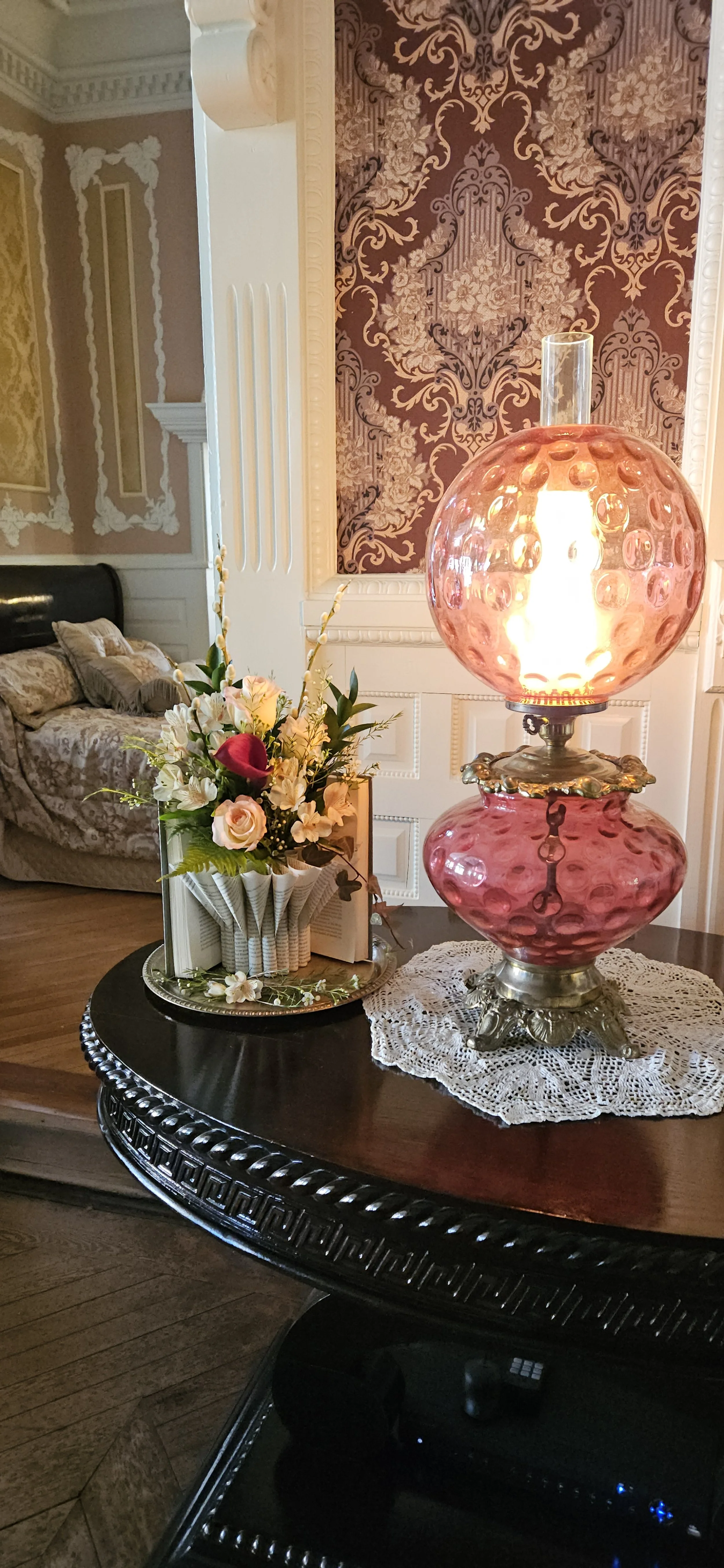 Scene at Korner's Folly Museum featuring Blooming Book with fresh flowers