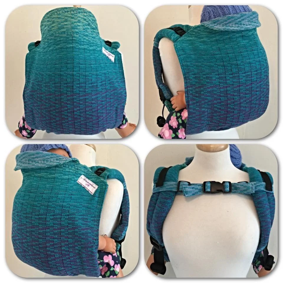 Photo of a teal and blue child carrier backpack displayed on a mannequin and a child wearing it. The backpack has padded shoulder straps, a waist strap, and is designed to carry a small child comfortably.