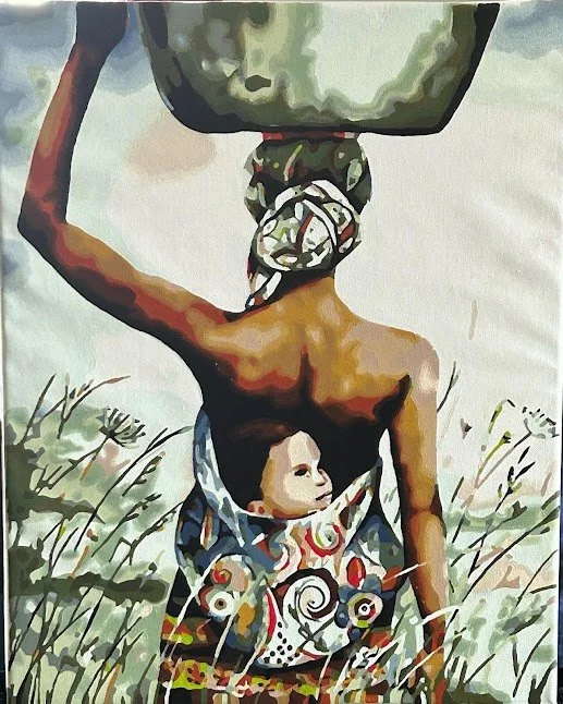 A woman with dark skin and a patterned cloth wrapped around her waist, carrying a basket on her head, standing in a grassy field.