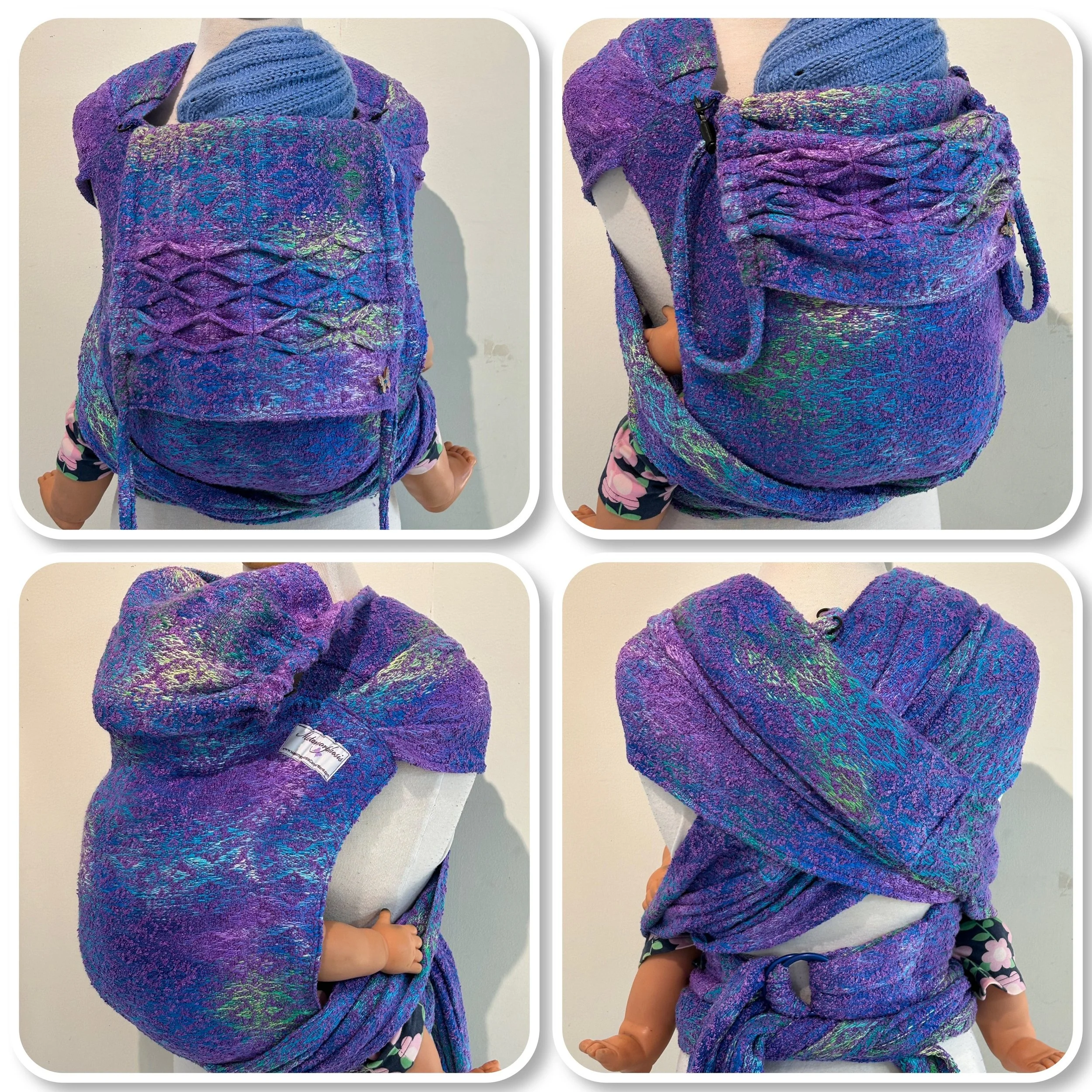 A purple woven baby carrier with adjustable straps, worn by a mannequin, with a teddy bear inside and a child's arm hanging out.