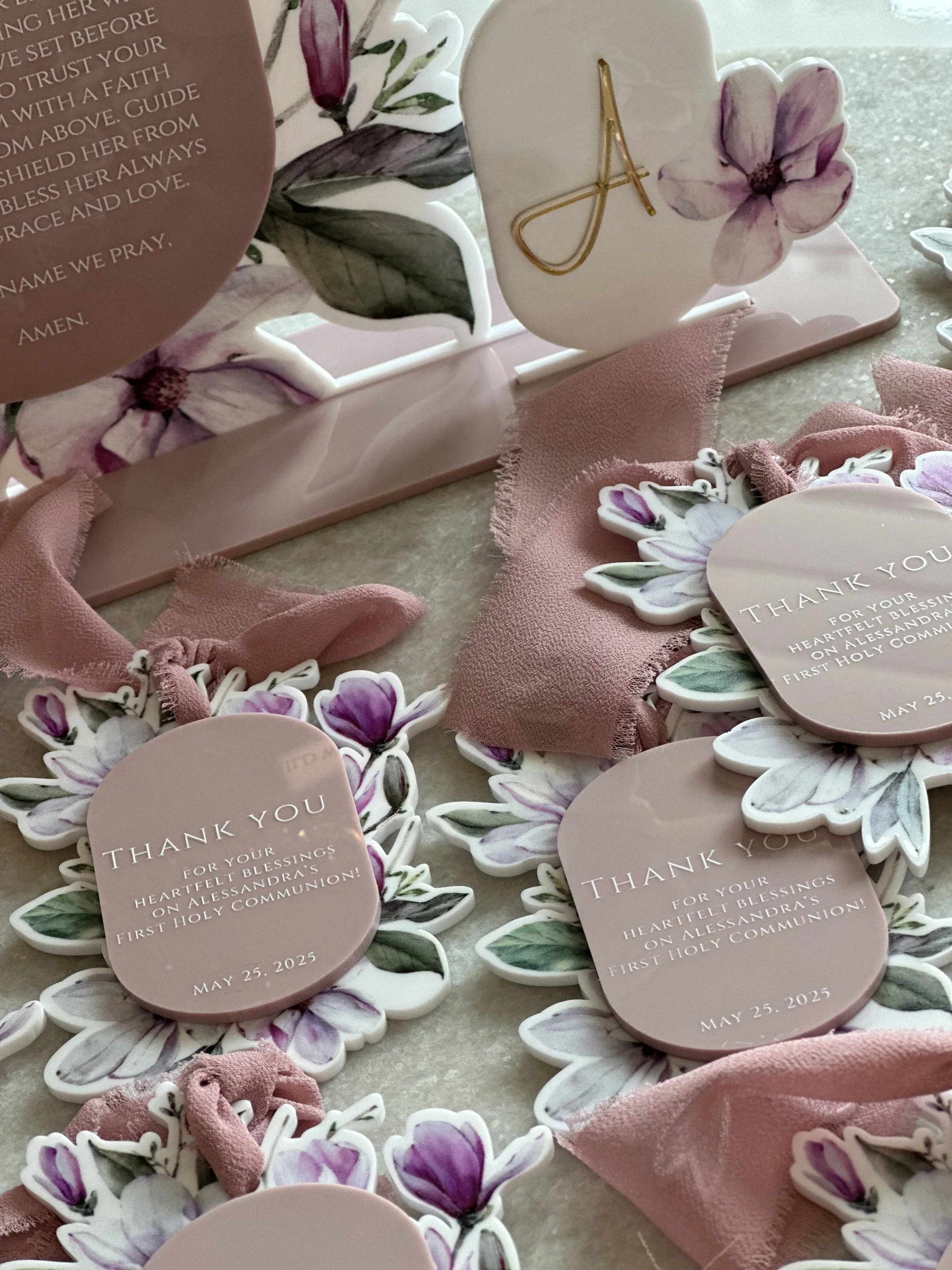Thank you cards with floral designs, thank you messages, pink fabric ribbons, and decorative elements for a First Holy Communion celebration on May 25, 2025.