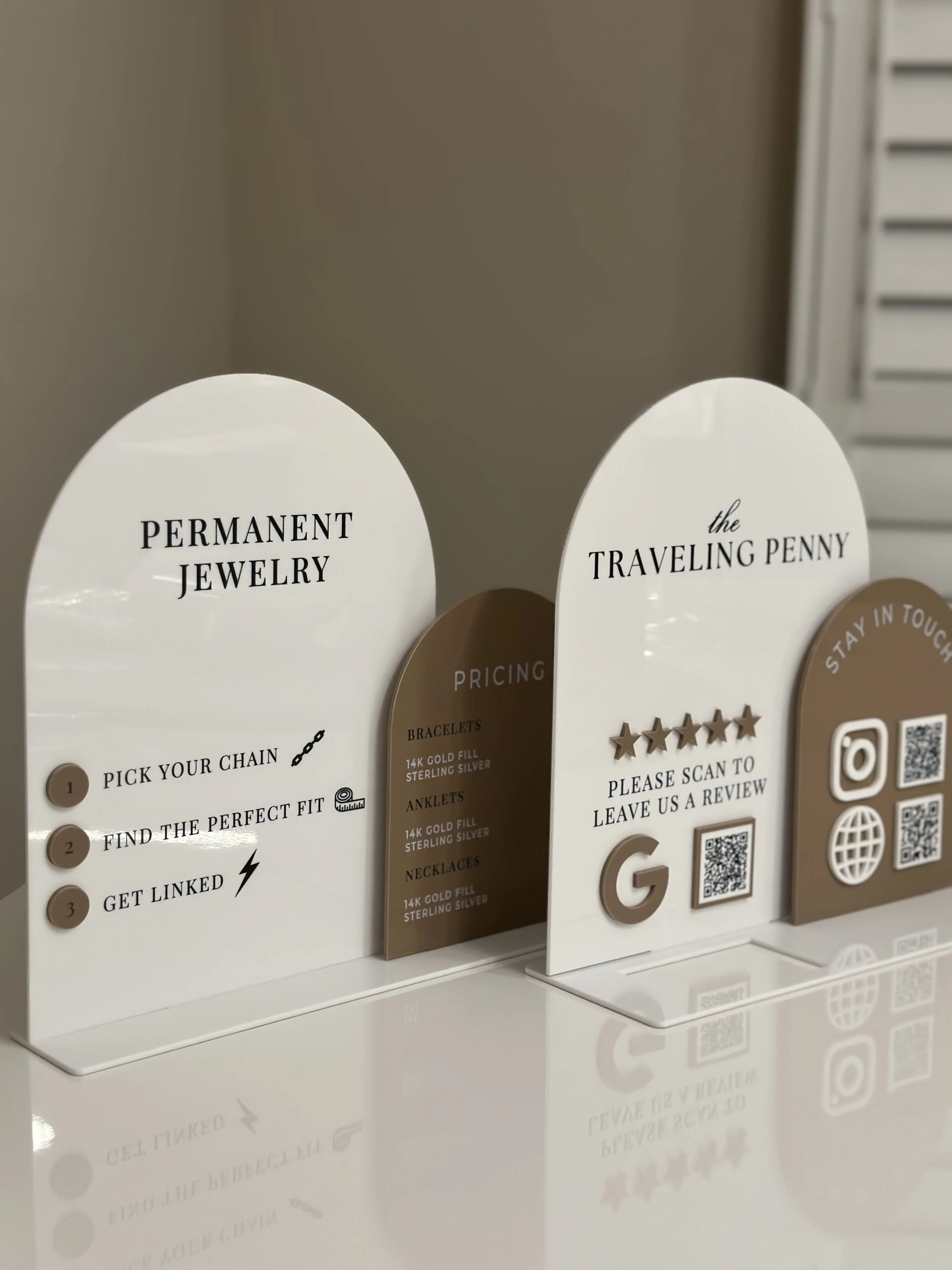 Display signs with information about jewelry and contact options, including QR codes for reviews and social media.