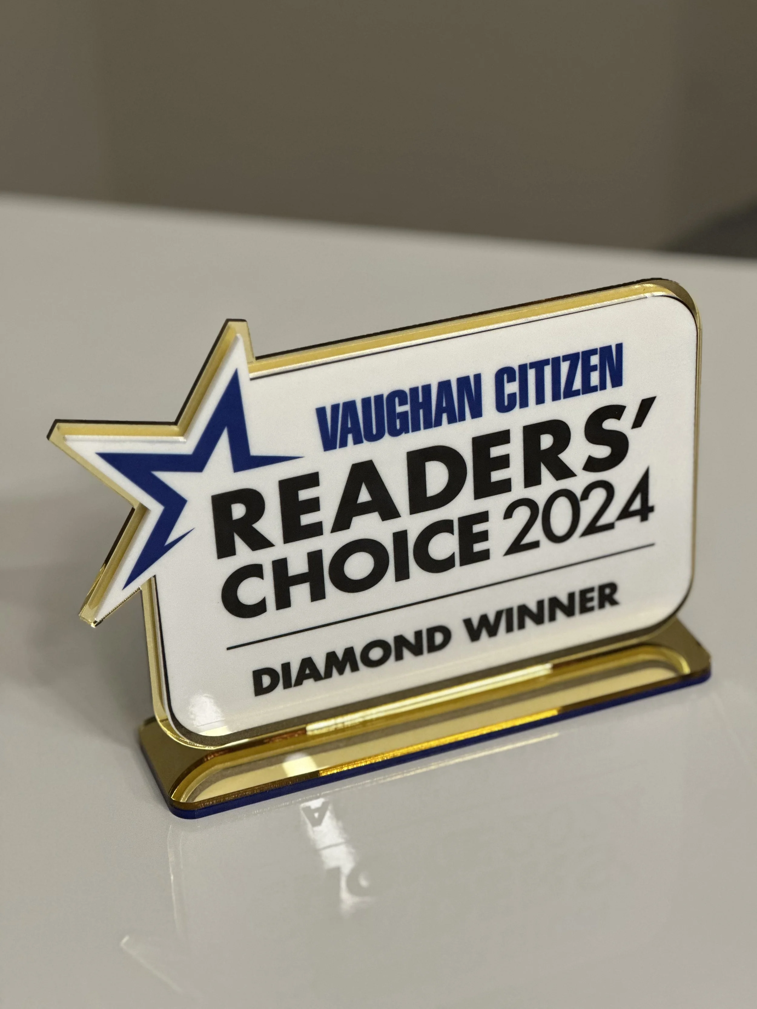 A rectangular sign with a gold border and a star logo. The sign reads 'Vaughan Citizen Readers' Choice 2024, Diamond Winner'.