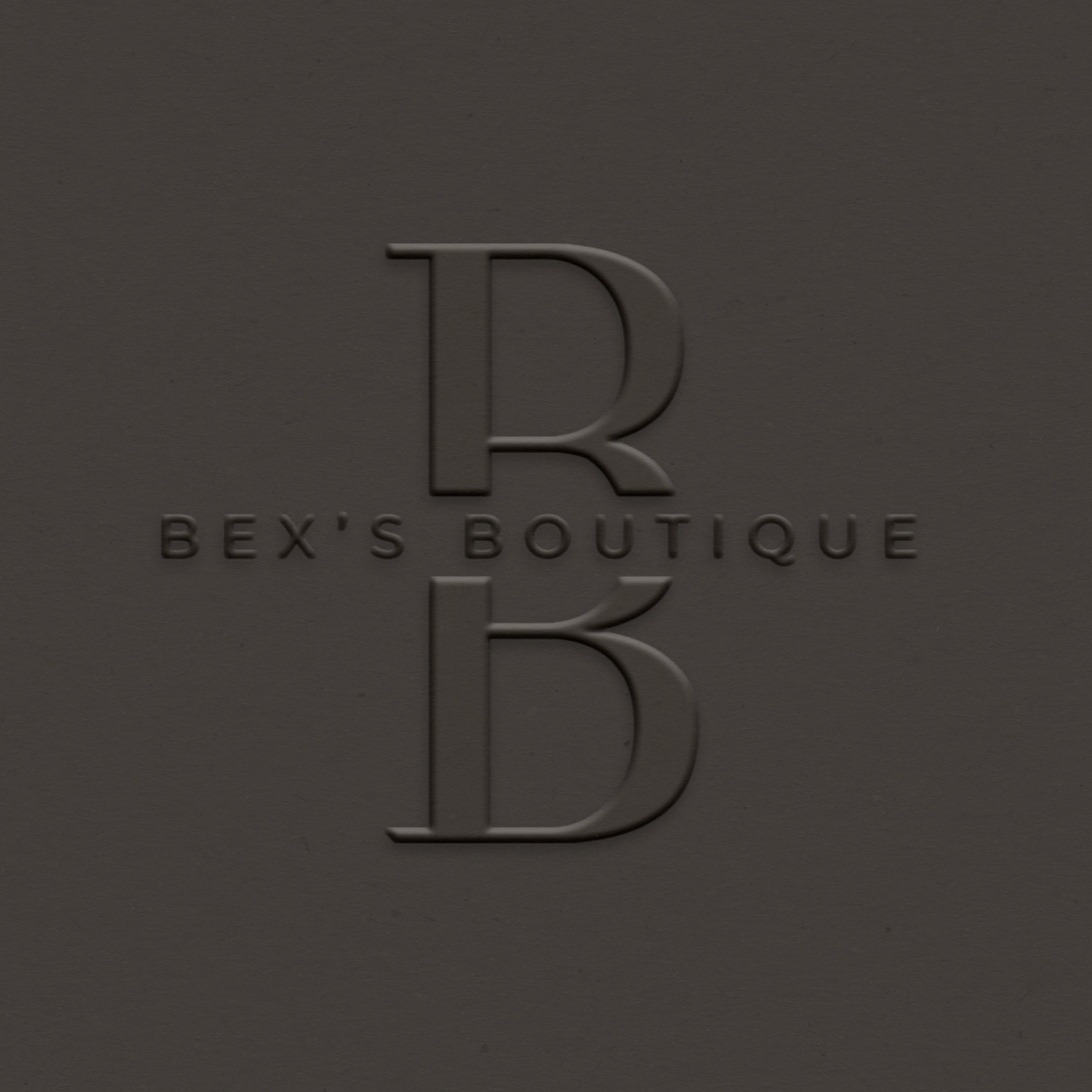 Embossed logo with large letter 'B' and smaller text 'BEX'S BOUTIQUE' on a gray background.