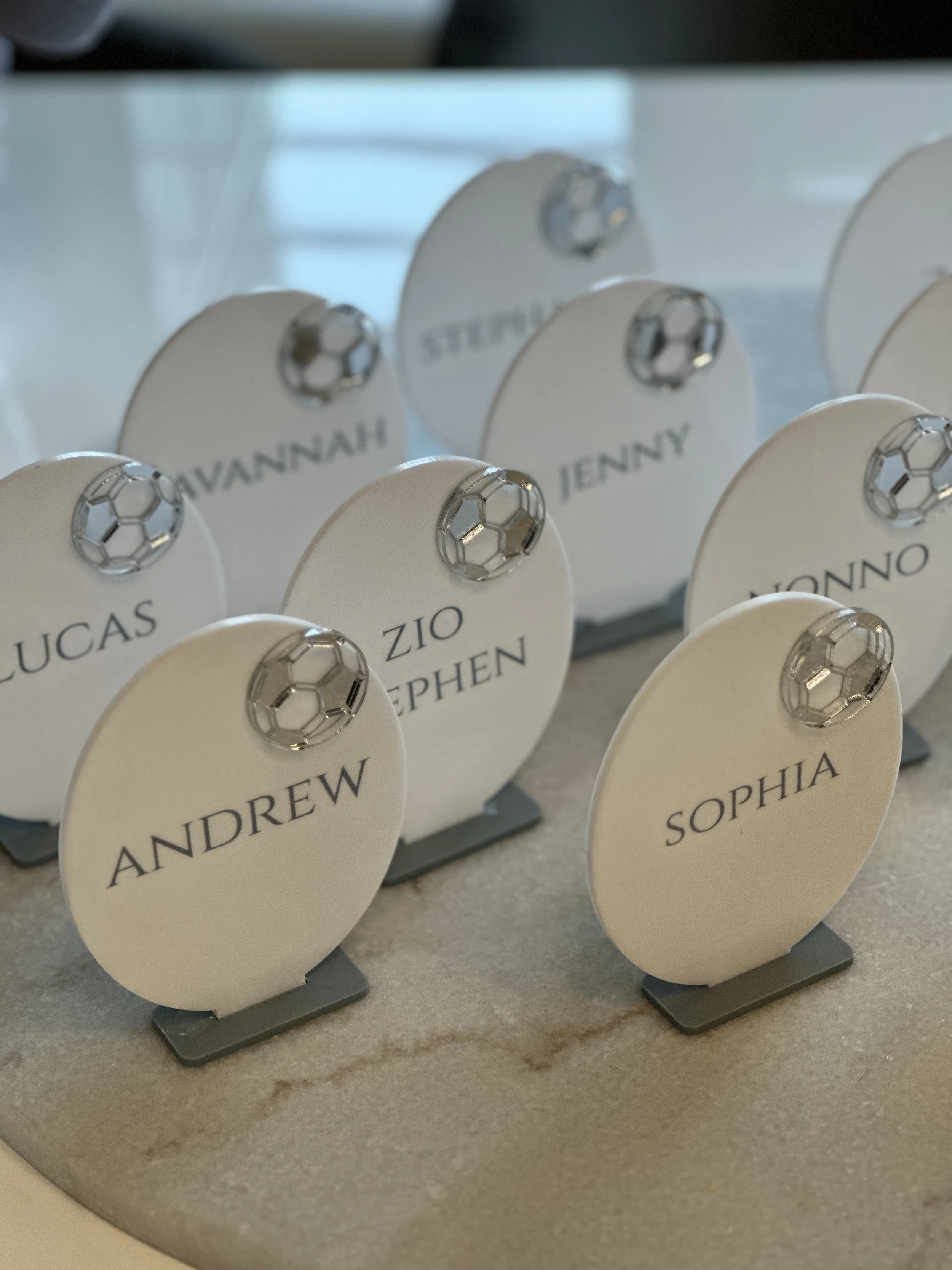 Table place cards with soccer ball decorations and guest names.