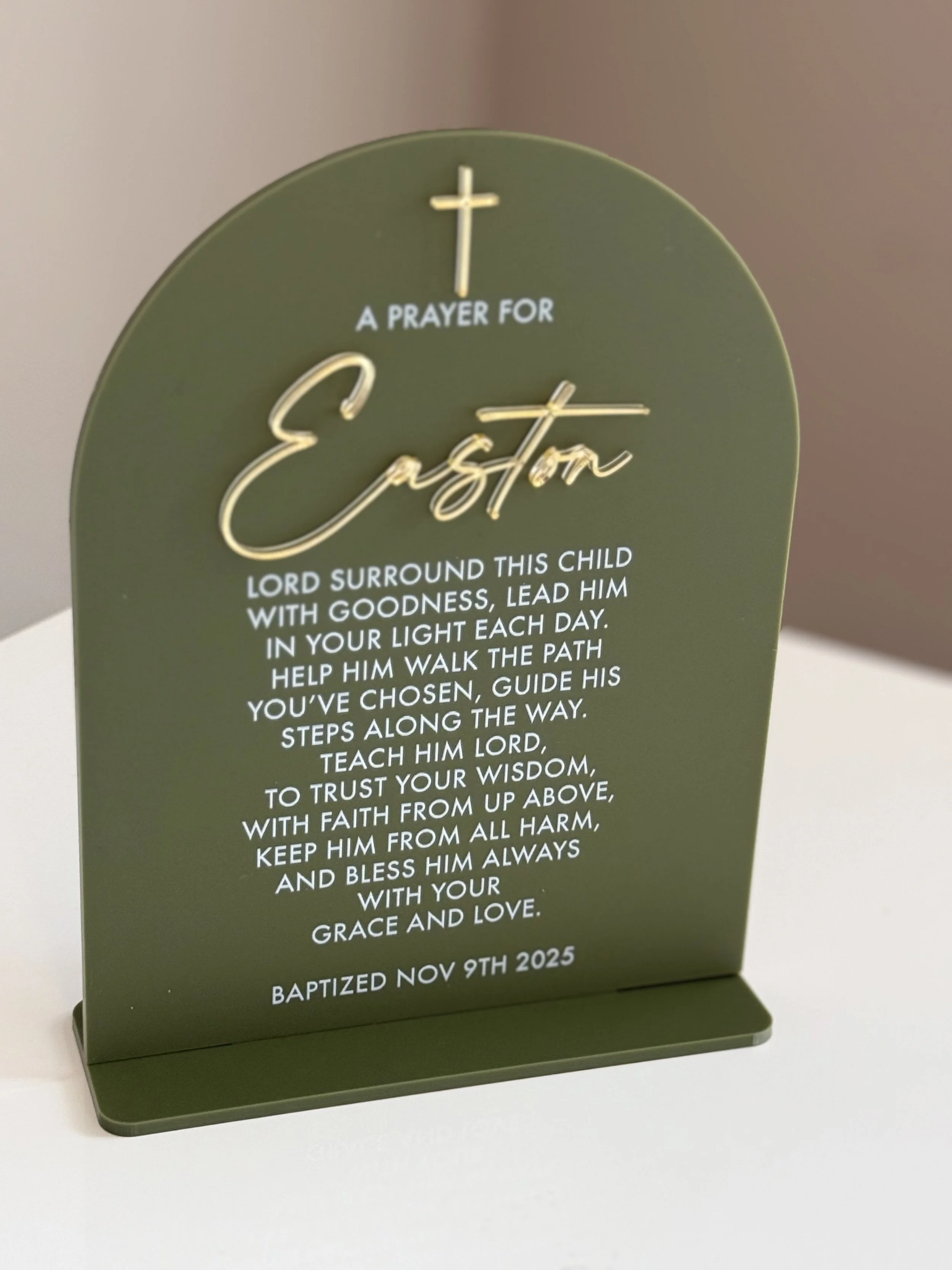 Olive green decorative plaque with gold cross and text for a prayer for a child named Easton, with baptism date Nov 9th, 2025.