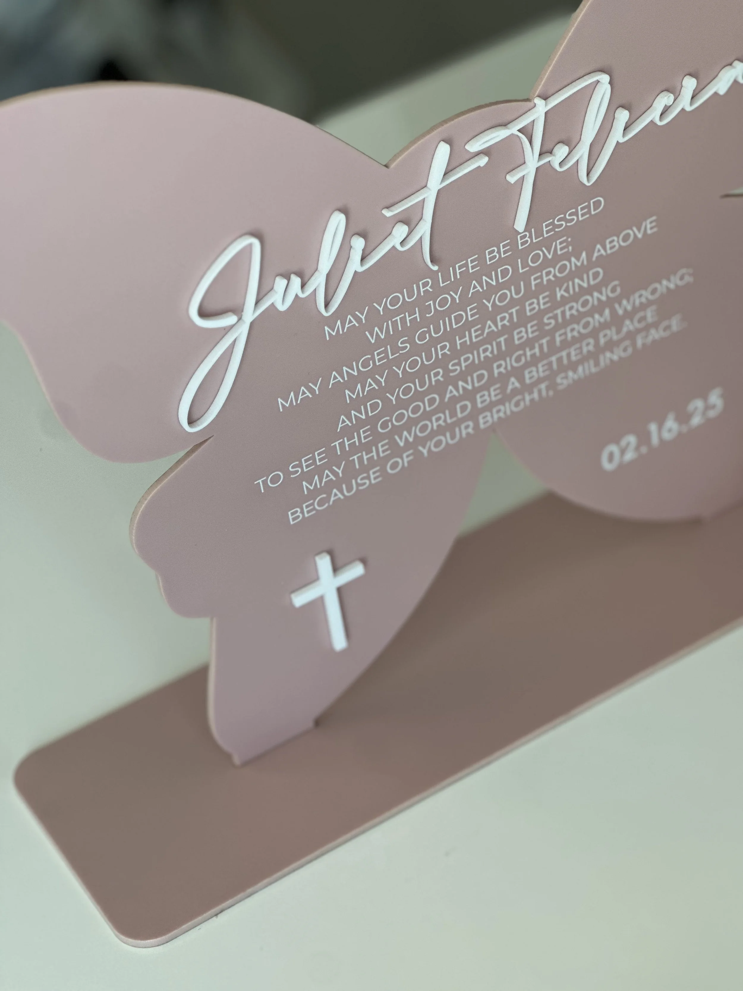Pink card with white and cursive writing that reads 'Just a Prayer' and a cross symbol, with a message for blessings, joy, love, and encouragement, along with a date '02.16.23'.