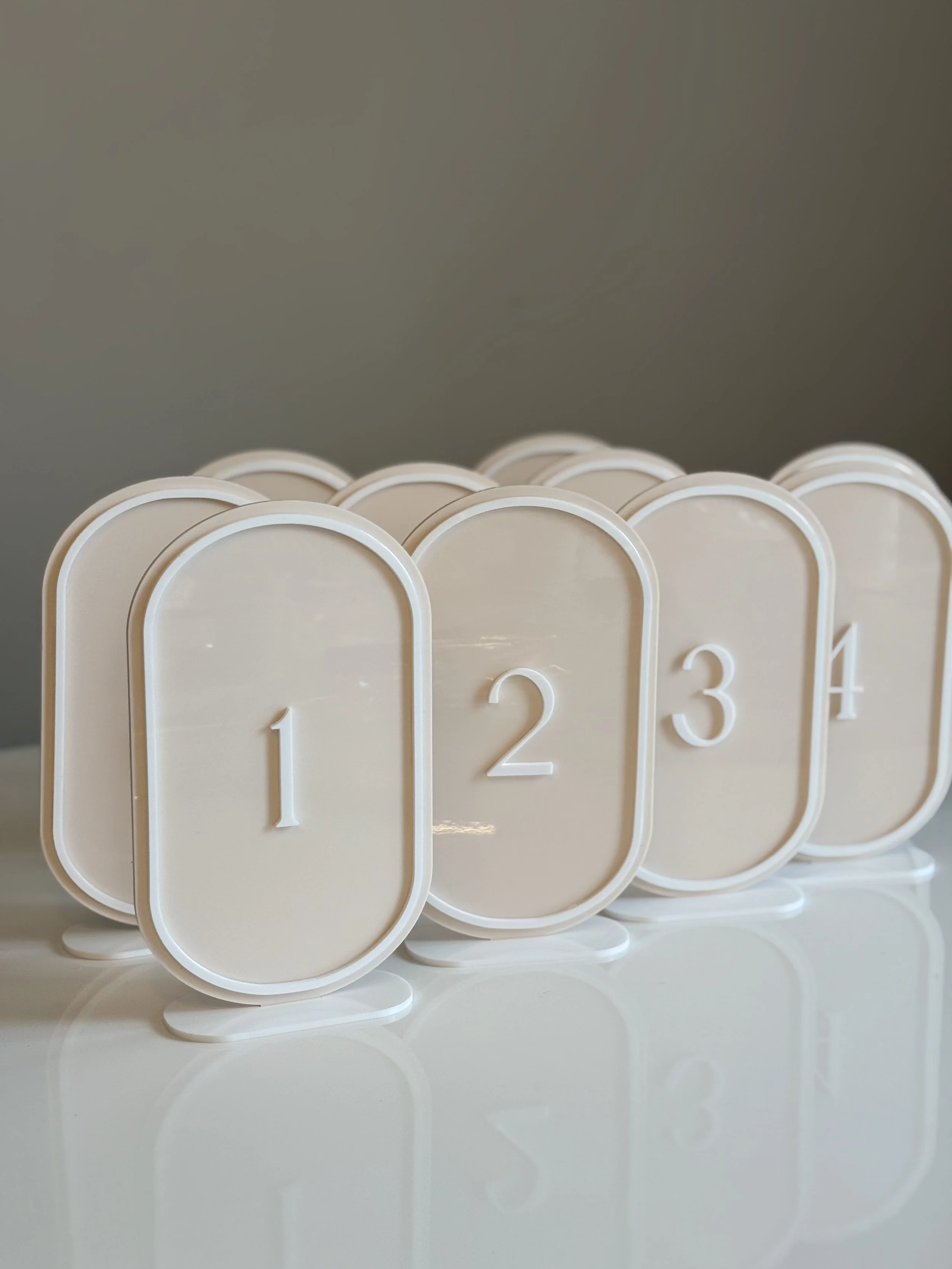 Stacked beige and white number tiles showing the numbers 1, 2, 3, and 4.