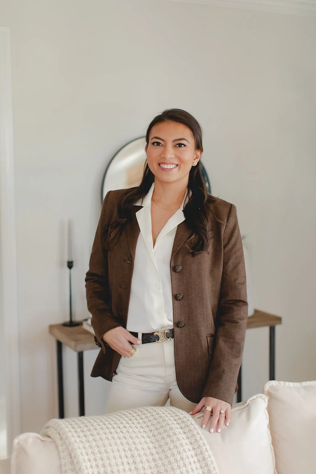 Business owner wearing a blazer in a professional pose in a photo studio
