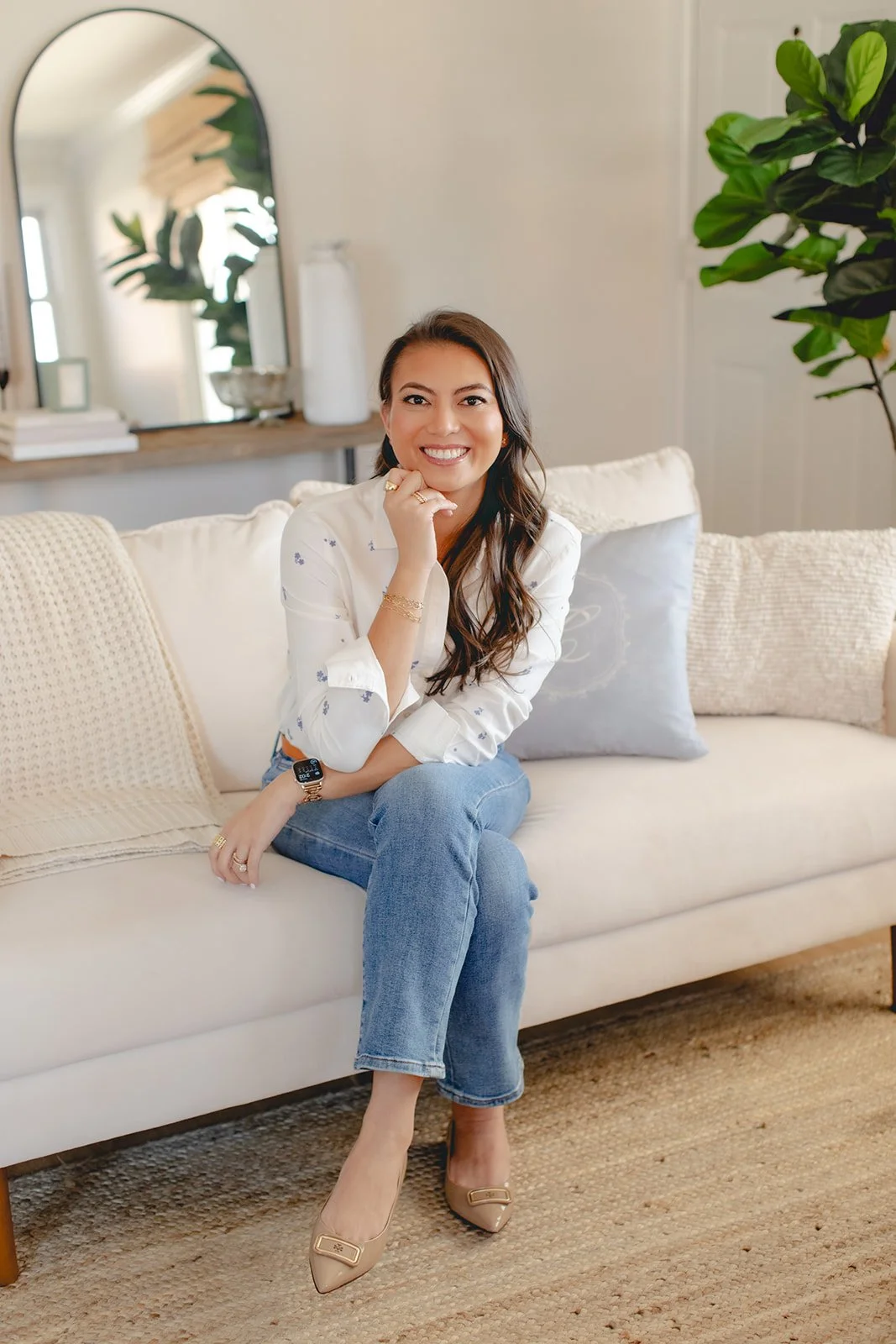 Digital ad strategist sitting on a couch and smiling at the camera