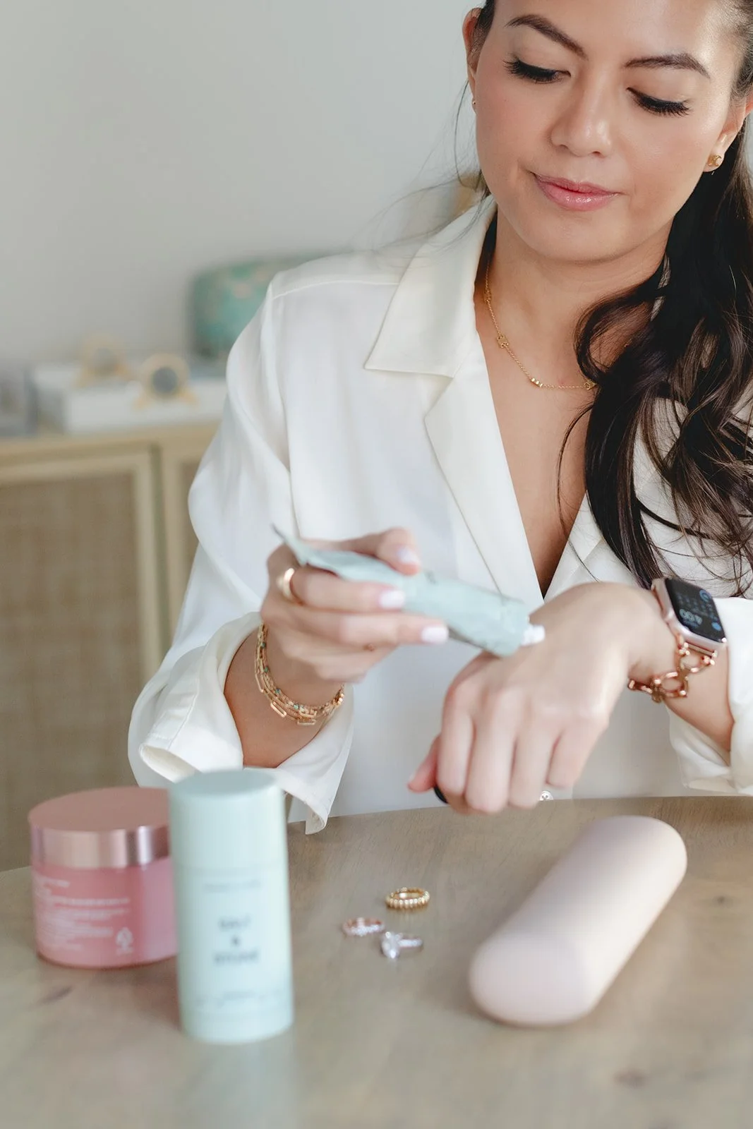 Business owner trying various beauty products at a table