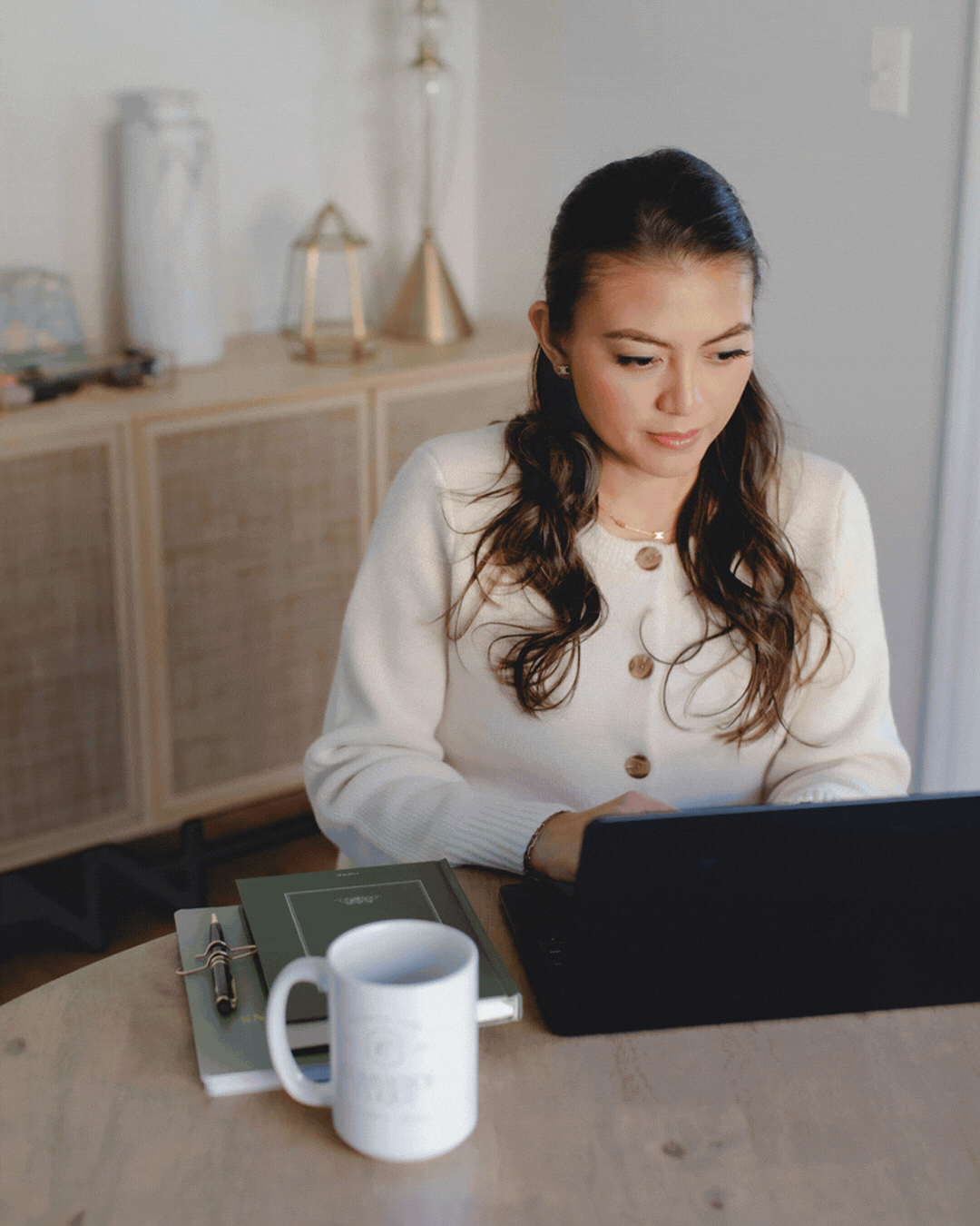 GIF of Commerce Clique owner working with clients, looking at products, and working on her business