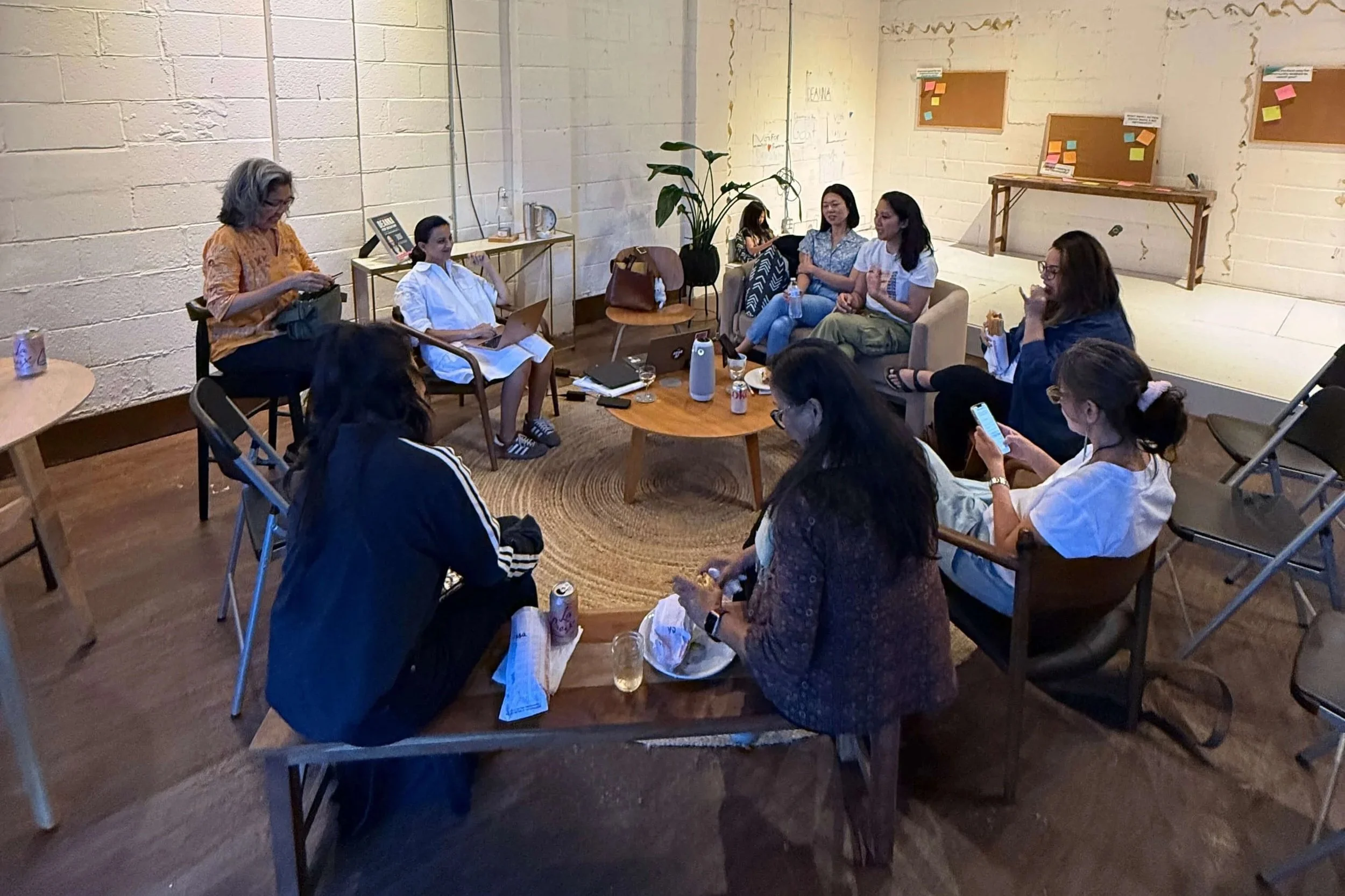 Group of women seated and gathered in a circle for an AAPI women's focus group for the Woven Together Project. 
