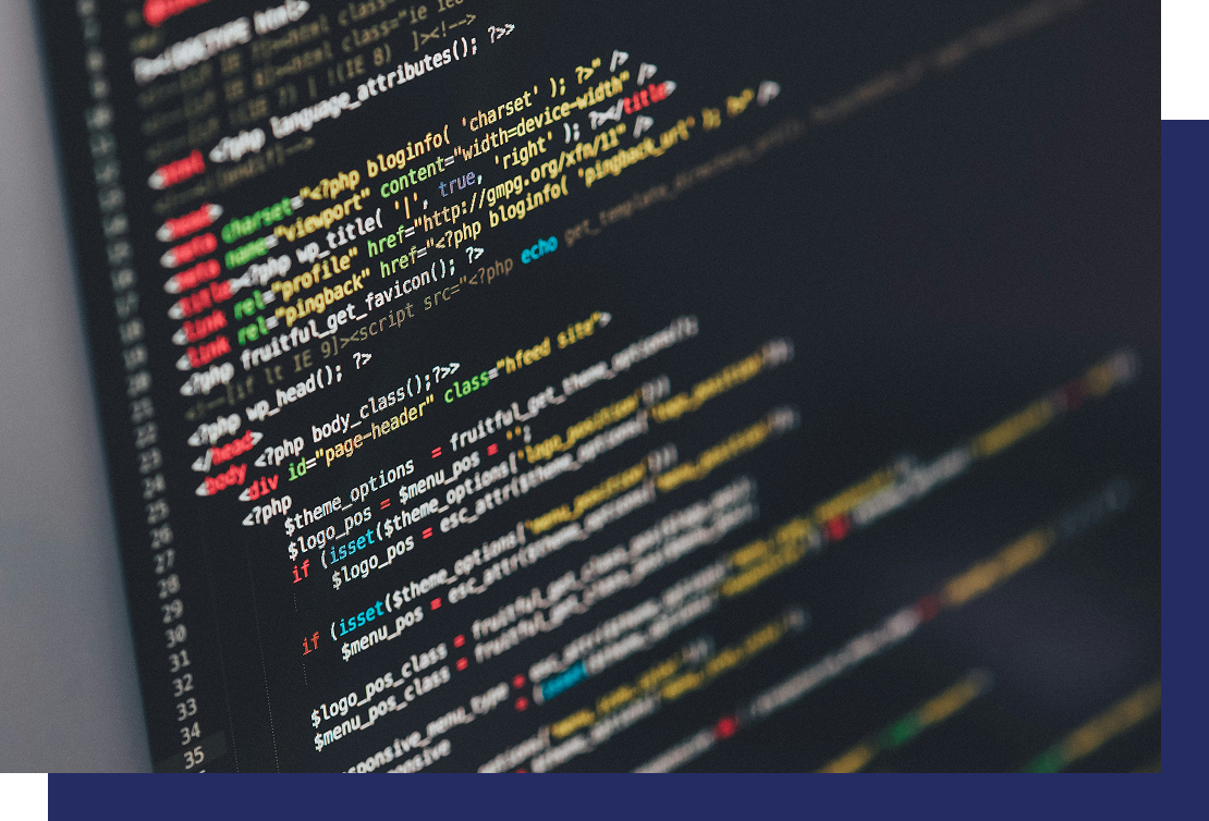 Close-up of a computer screen displaying colorful PHP/HTML code with syntax highlighting.