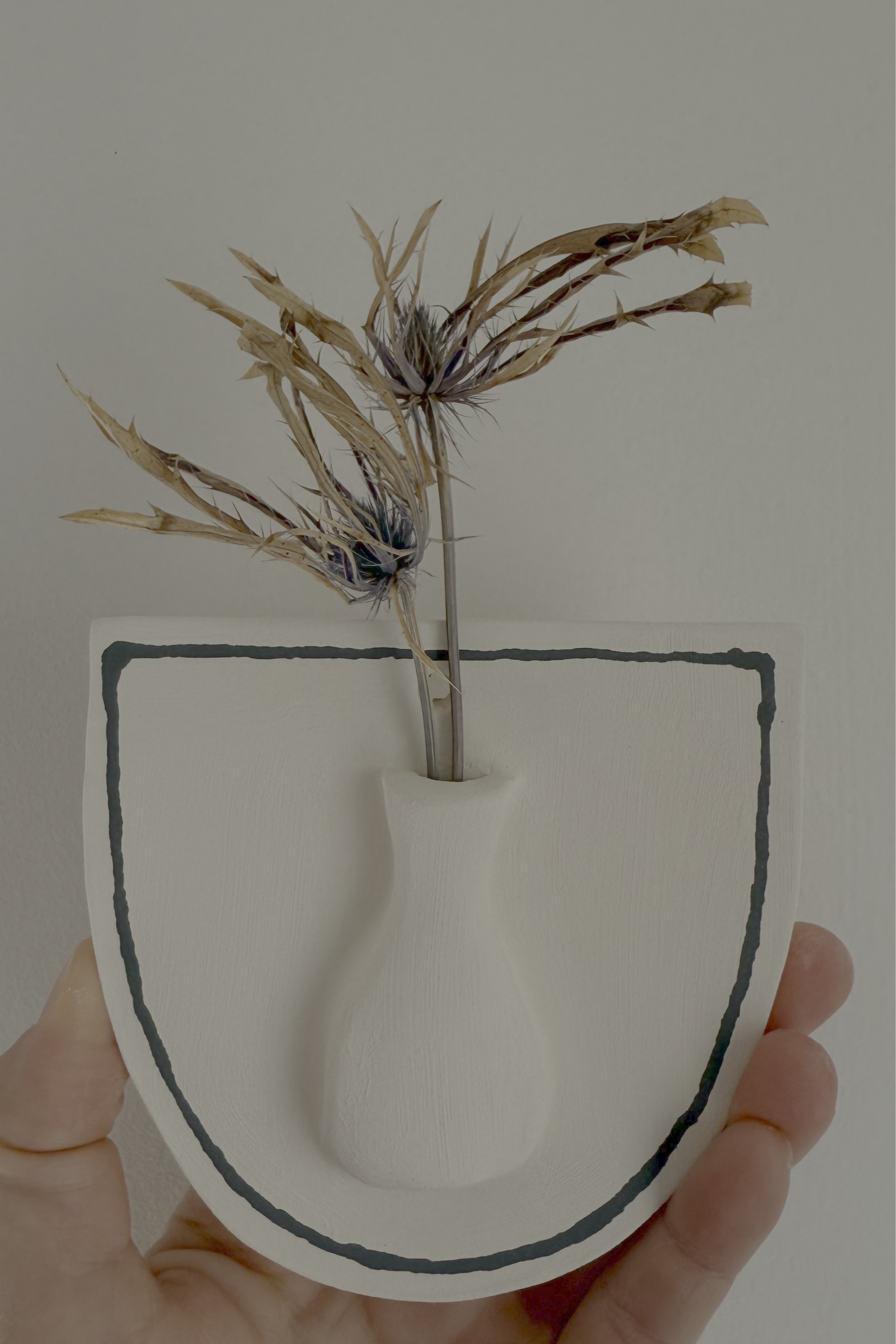 ceramic home decor piece with dried flowers