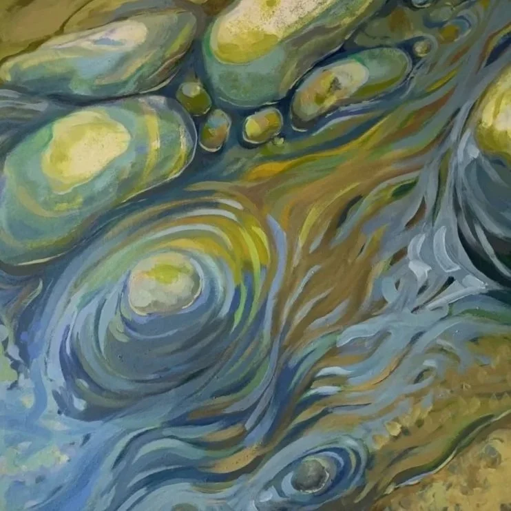 stream swirling past rounded rocks
