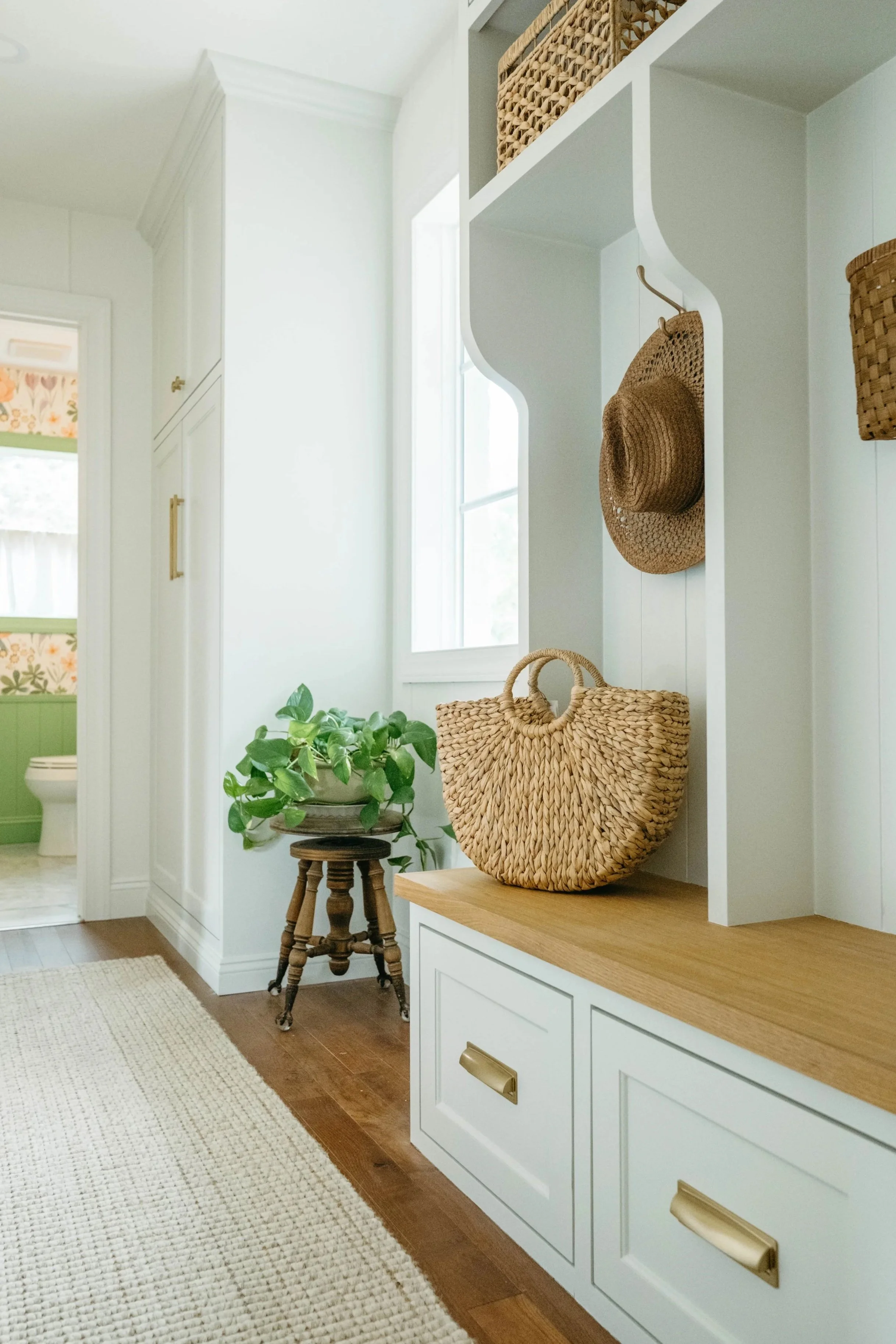 Custom mudroom lockers finished with Rubio Monocoat. Peek into colorful powder bathroom.