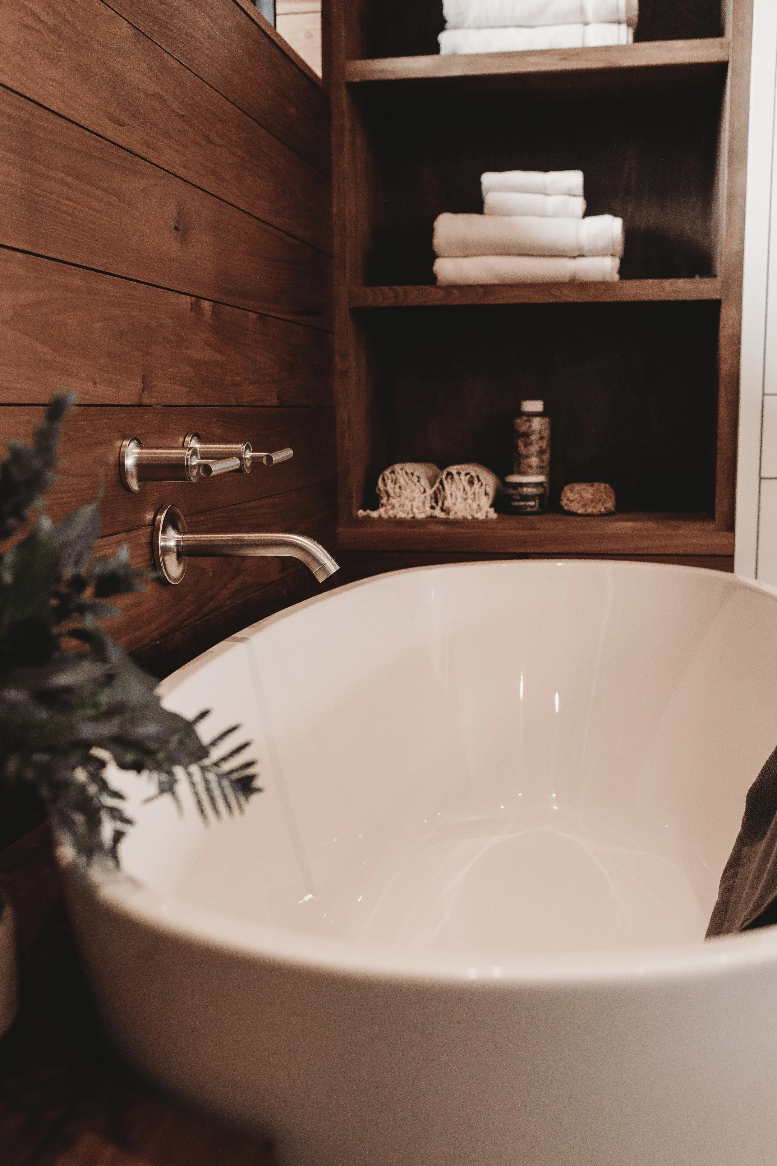 Freestanding bathtub with a custom wood surround.