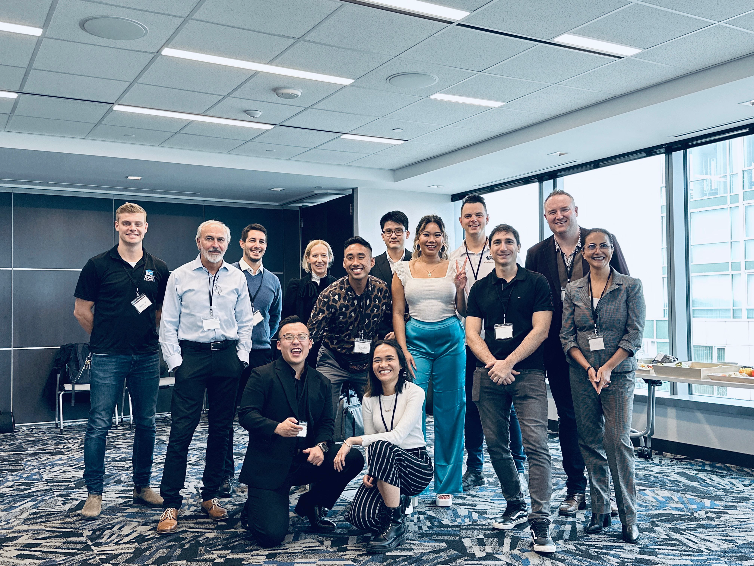 Vanessa Luv - Vancouver BC - Divera Leadership - Leadership Workshops Vancouver - Group of diverse professionals in a conference room, smiling and posing for a photo.