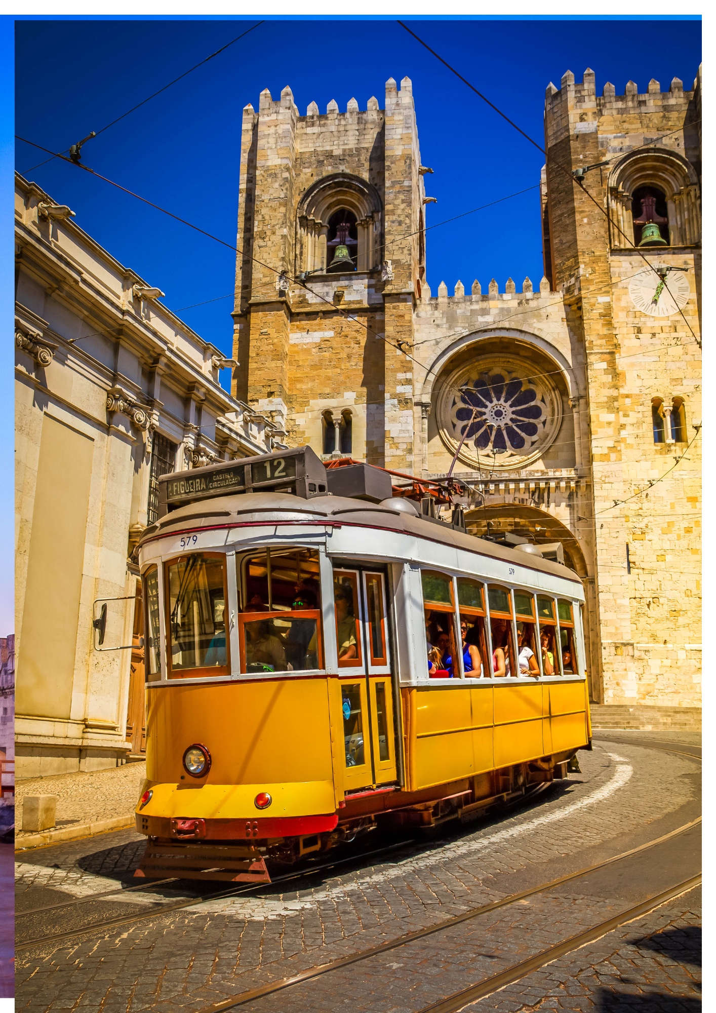 Historic yellow tram on cobblestone street passing by a large stone cathedral with tall towers and a rose window, under a clear blue sky.