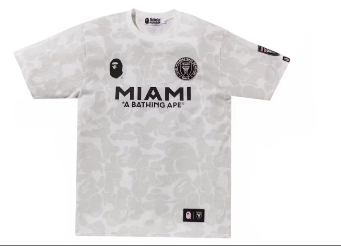 White camouflage Miami soccer jersey featuring the Miami FC logo, a black ape face logo, and the words 'MIAMI *A BATHING APE*' on the front.