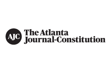 Logo of The Atlanta Journal-Constitution with black circle and white letters AJC, and text to the right reading 'The Atlanta Journal-Constitution'.