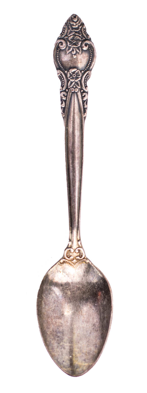 An antique silver spoon with ornate floral and scroll details on the handle.