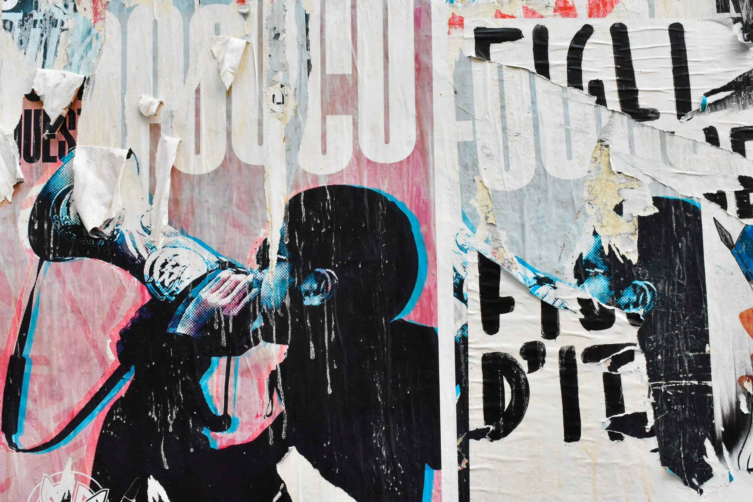 Abstract image of a segment of a weathered poster showing random letters in black and white, and the image of a young black man with a short afro, sunglasses and a megaphone.