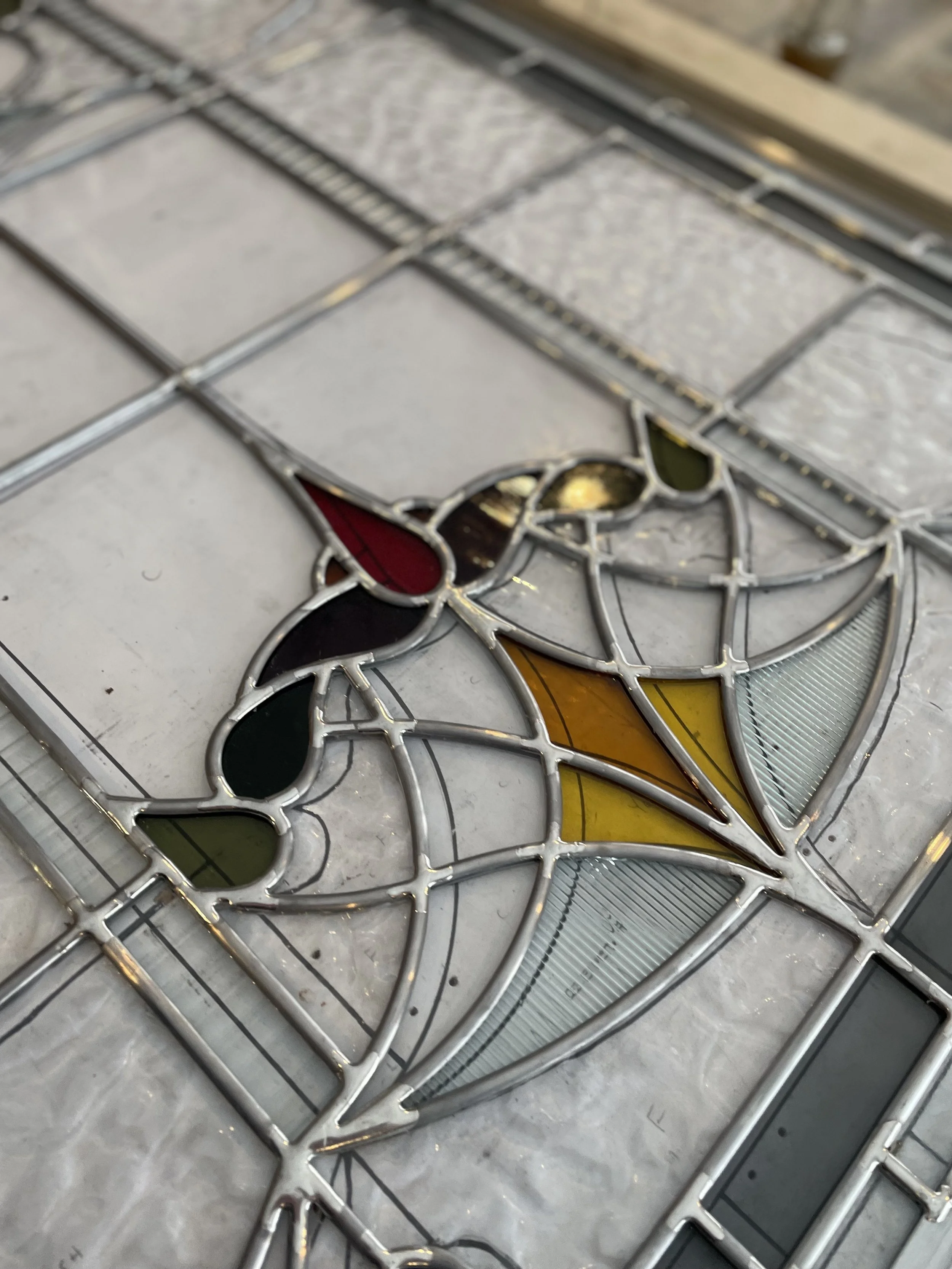 Custom stained glass detailing within residential entryway.