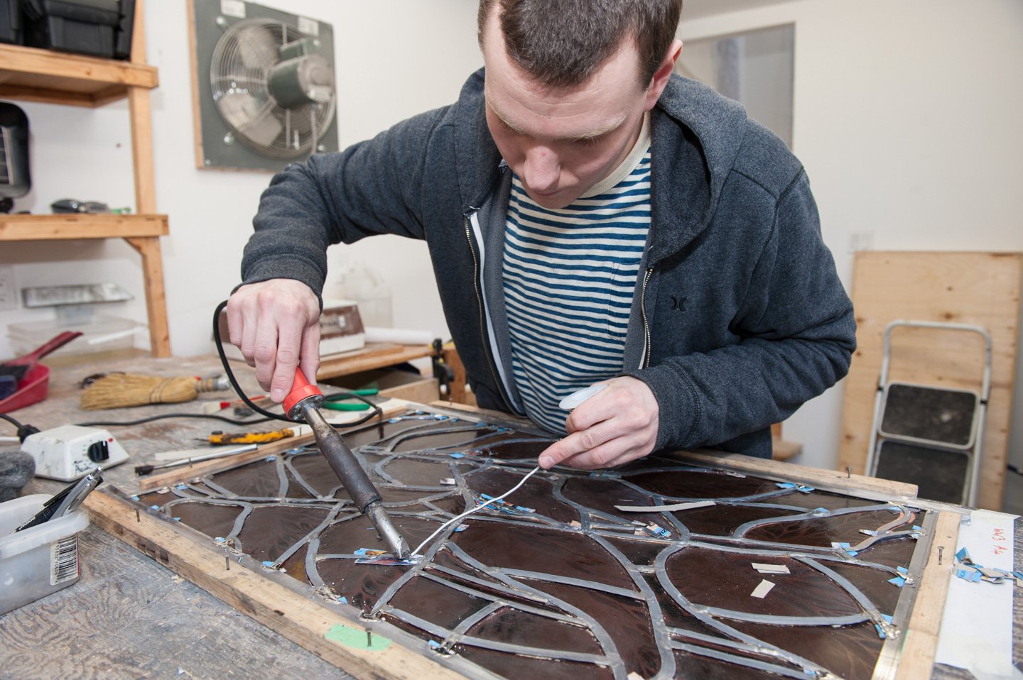 Leaded glass window fabrication in studio
